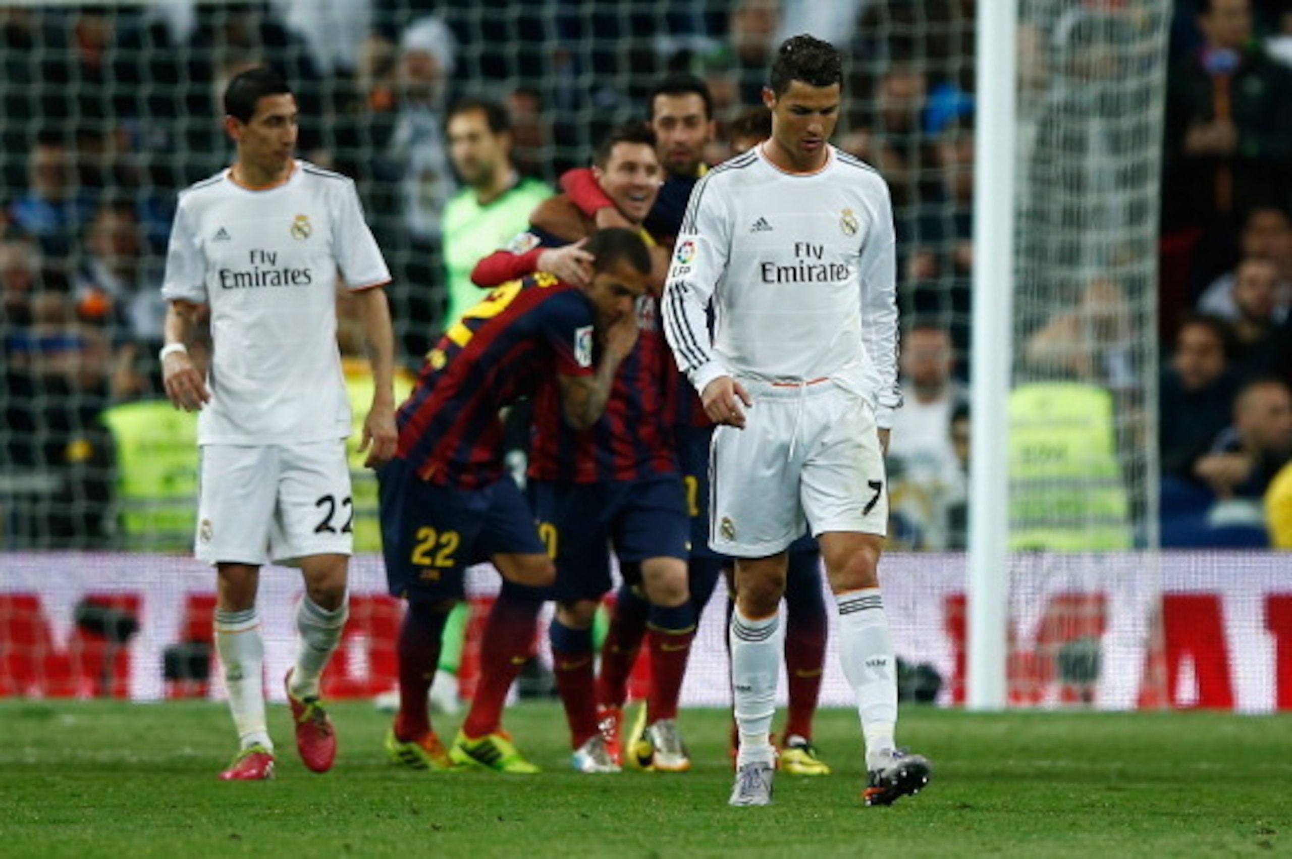 MADRID, SPAIN - MARCH 23: Lionel Messi of Barcelona celebrates scoring his team's third goal with team mates as Cristiano Ronaldo of Real Madrid look dejected during the La Liga match between Real Madrid CF and FC Barcelona at the Bernabeu on March 23, 2 MADRID, SPAIN - MARCH 23: Lionel Messi of Barcelona celebrates scoring his team's third goal with team mates as Cristiano Ronaldo of Real Madrid look dejected during the La Liga match between Real Madrid CF and FC Barcelona at the Bernabeu on March 23, 2