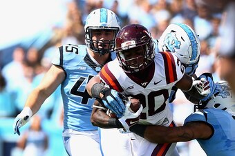 CHAPEL HILL, NC - OCTOBER 04:  Deon Newsome #20 of the Virginia Tech Hokies runs with the ball against the defense of the North Carolina Tar Heels during their game at Kenan Stadium on October 4, 2014 in Chapel Hill, North Carolina.  (Photo by Streeter Le