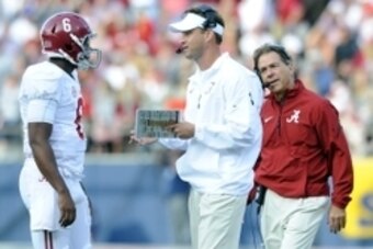 Oct 4, 2014; Oxford, MS, USA; Alabama Crimson offensive coordinator Lane Kiffin talks with quarterback Blake Sims (6) as head coach Nick Saban looks on during the second half against Mississippi Rebels at Vaught-Hemingway Stadium. Mandatory Credit: Christ