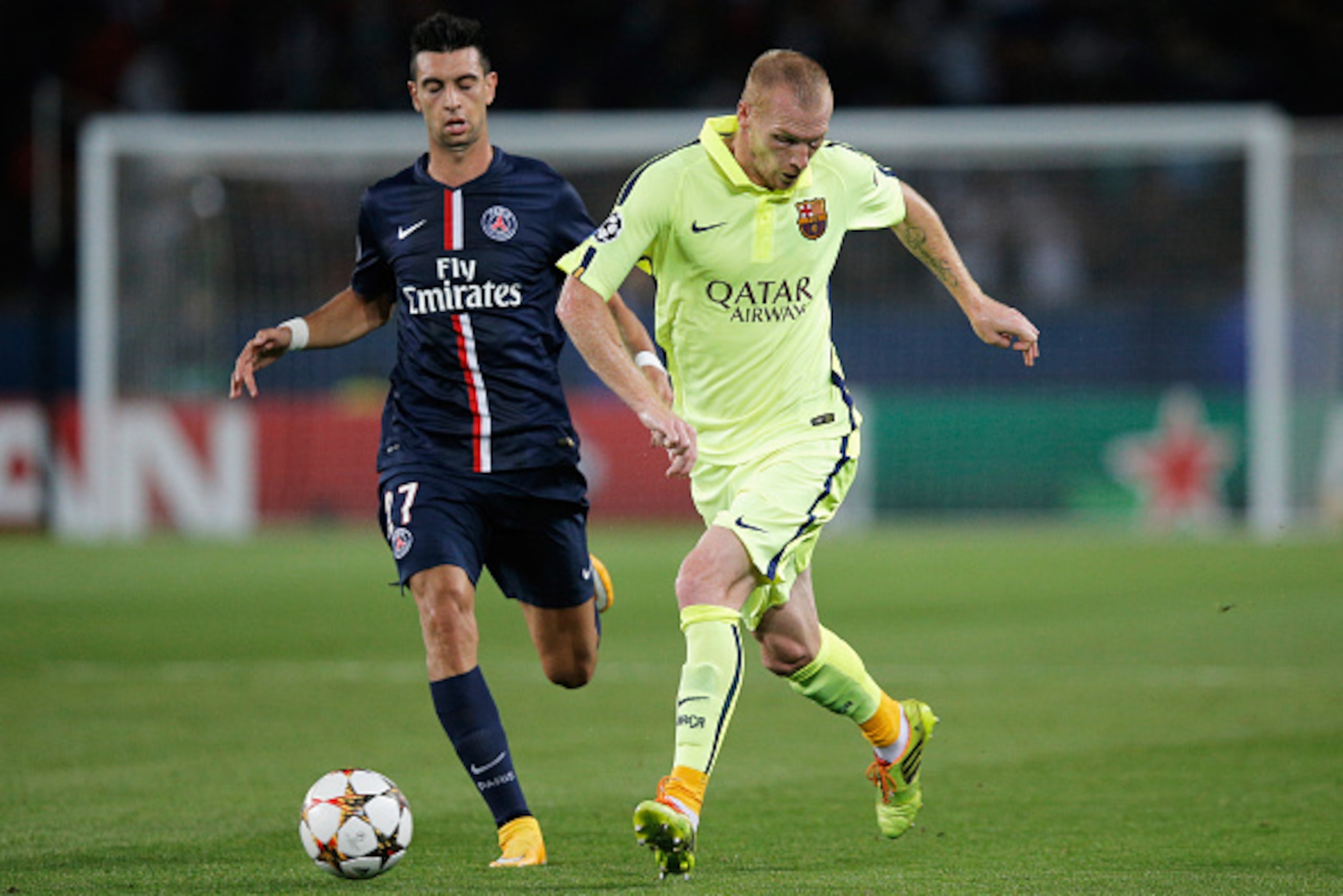 PARIS, FRANCE - SEPTEMBER 30:  Javier Pastore  of PSG chases Jeremy Mathieu of Barcelona during the Group F UEFA Champions League match between Paris Saint-Germain v FC Barcelona held at Parc des Princes on September 30, 2014 in Paris, France.  (Photo by 