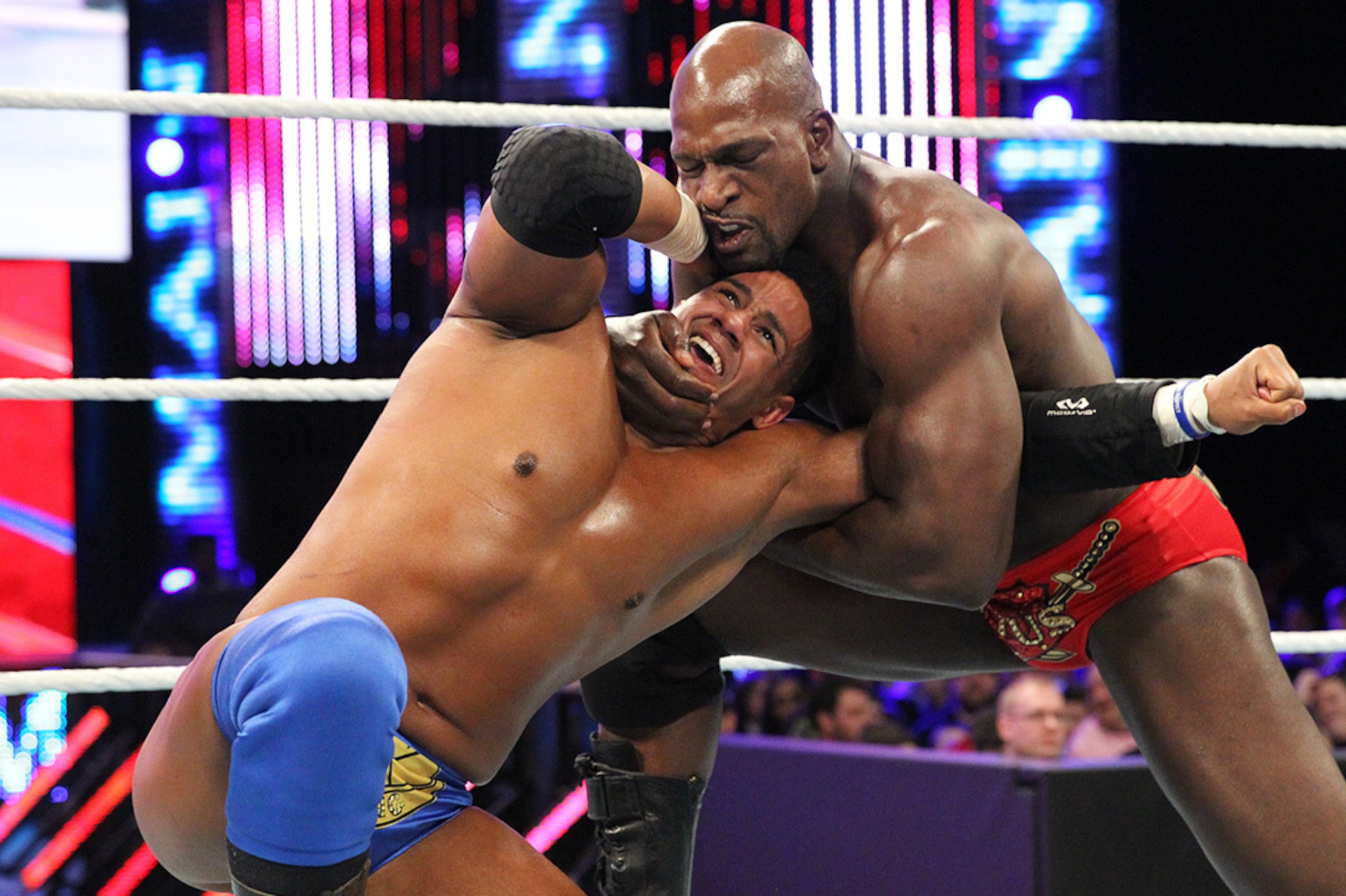 Darren Young struggles to escape Titus O'Neil's grip.