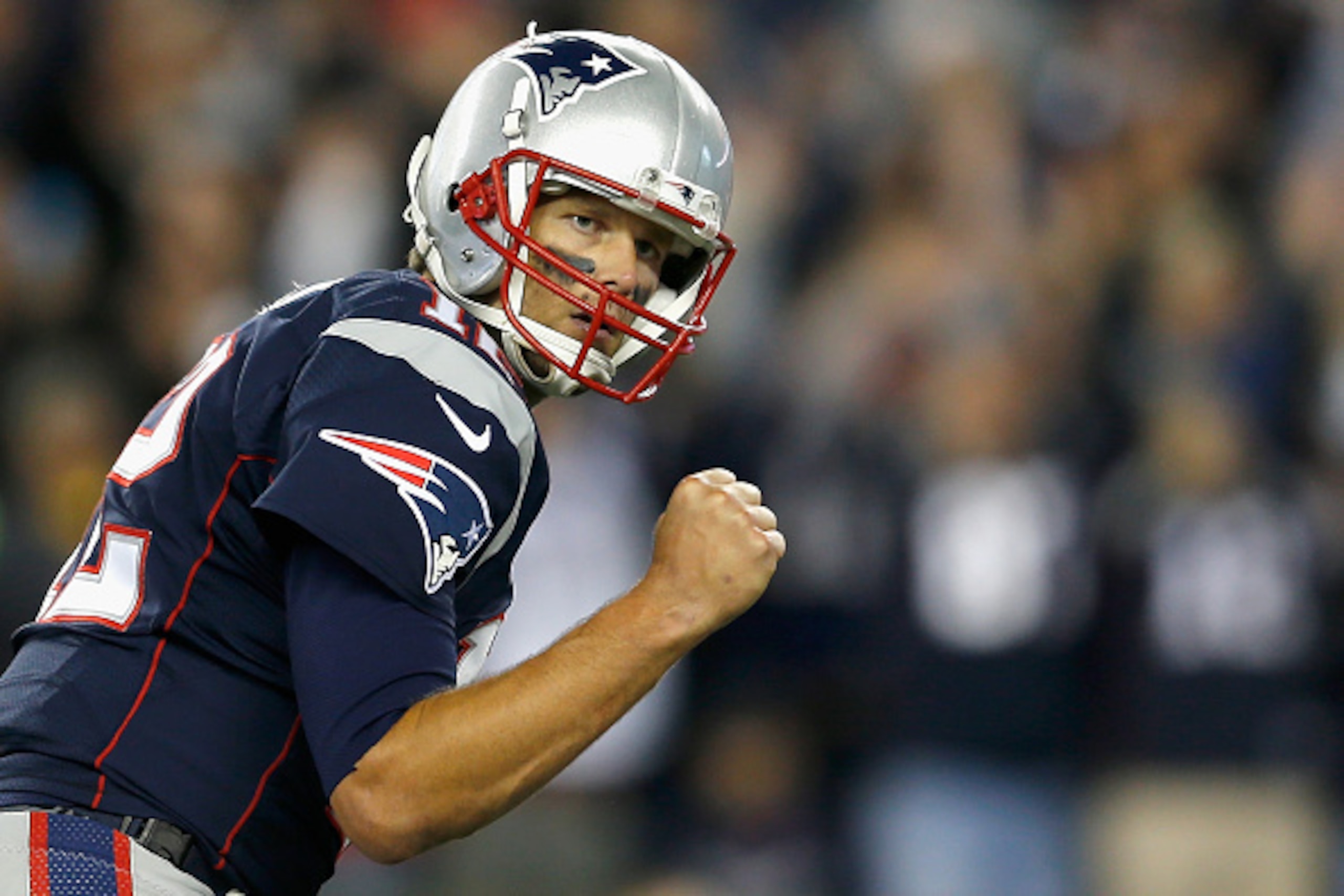 FOXBORO, MA - OCTOBER 05:  Tom Brady #12 of the New England Patriots reacts after throwing a touchdown pass during the third quarter against the Cincinnati Bengals at Gillette Stadium on October 5, 2014 in Foxboro, Massachusetts.  (Photo by Jim Rogash/Get