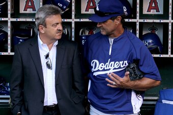 ANAHEIM, CA - JULY 1:  Manager Don Mattingly and general manager Ned Colletti of the Los Angeles Dodgers converse in the dugout before the game with the Los Angeles Angels of Anaheim on July 1, 2011 at Angel Stadium in Anaheim, California.   (Photo by Ste
