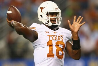 ARLINGTON, TX - SEPTEMBER 13:  Tyrone Swoopes #18 of the Texas Longhorns throws against the UCLA Bruins in the second quarter at AT&T Stadium on September 13, 2014 in Arlington, Texas.  (Photo by Ronald Martinez/Getty Images)