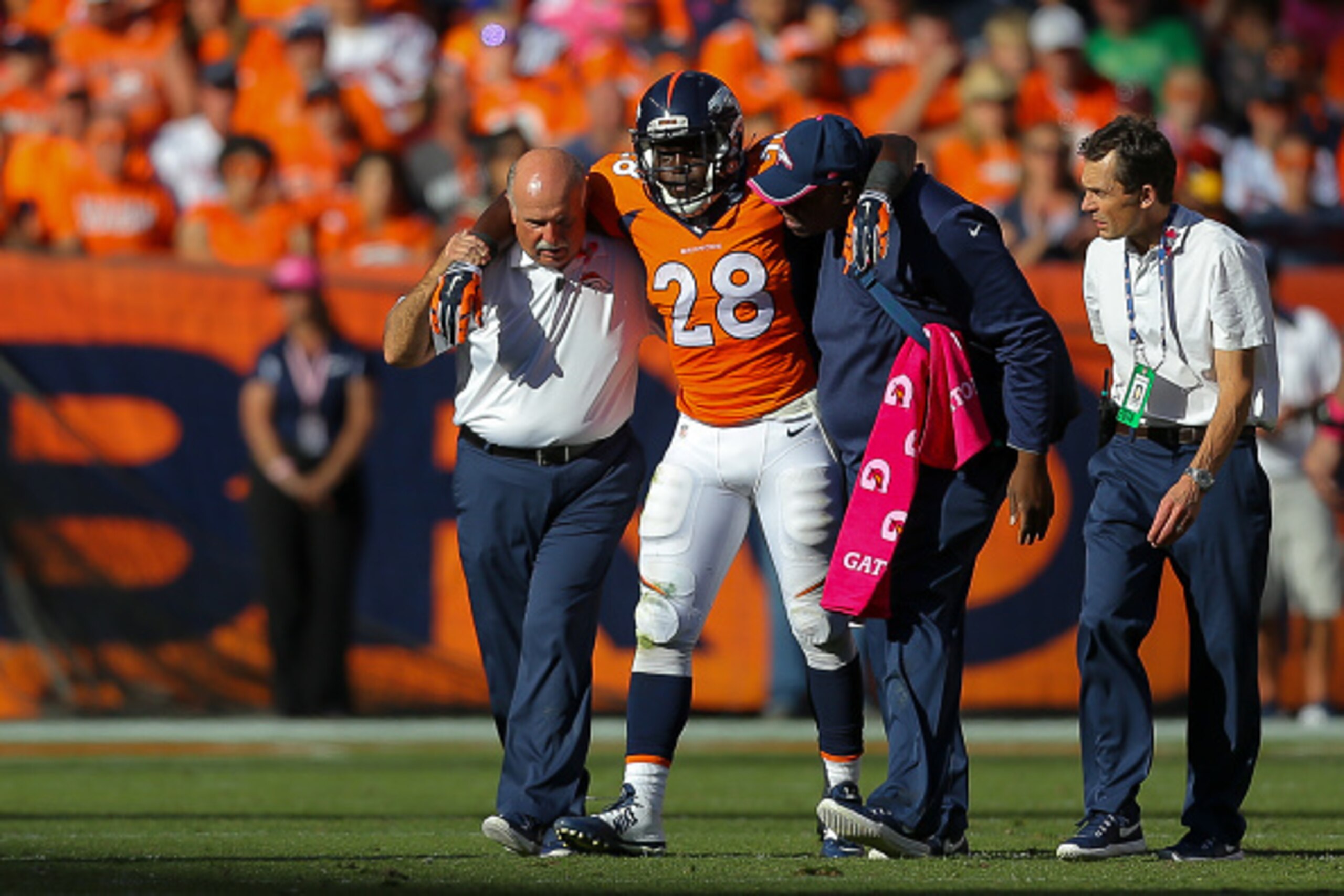DENVER, CO - OCTOBER 5:  Running back Montee Ball #28 of the Denver Broncos is helped off the field after an injury during a game against the Arizona Cardinals at Sports Authority Field at Mile High on October 5, 2014 in Denver, Colorado.  (Photo by Justi