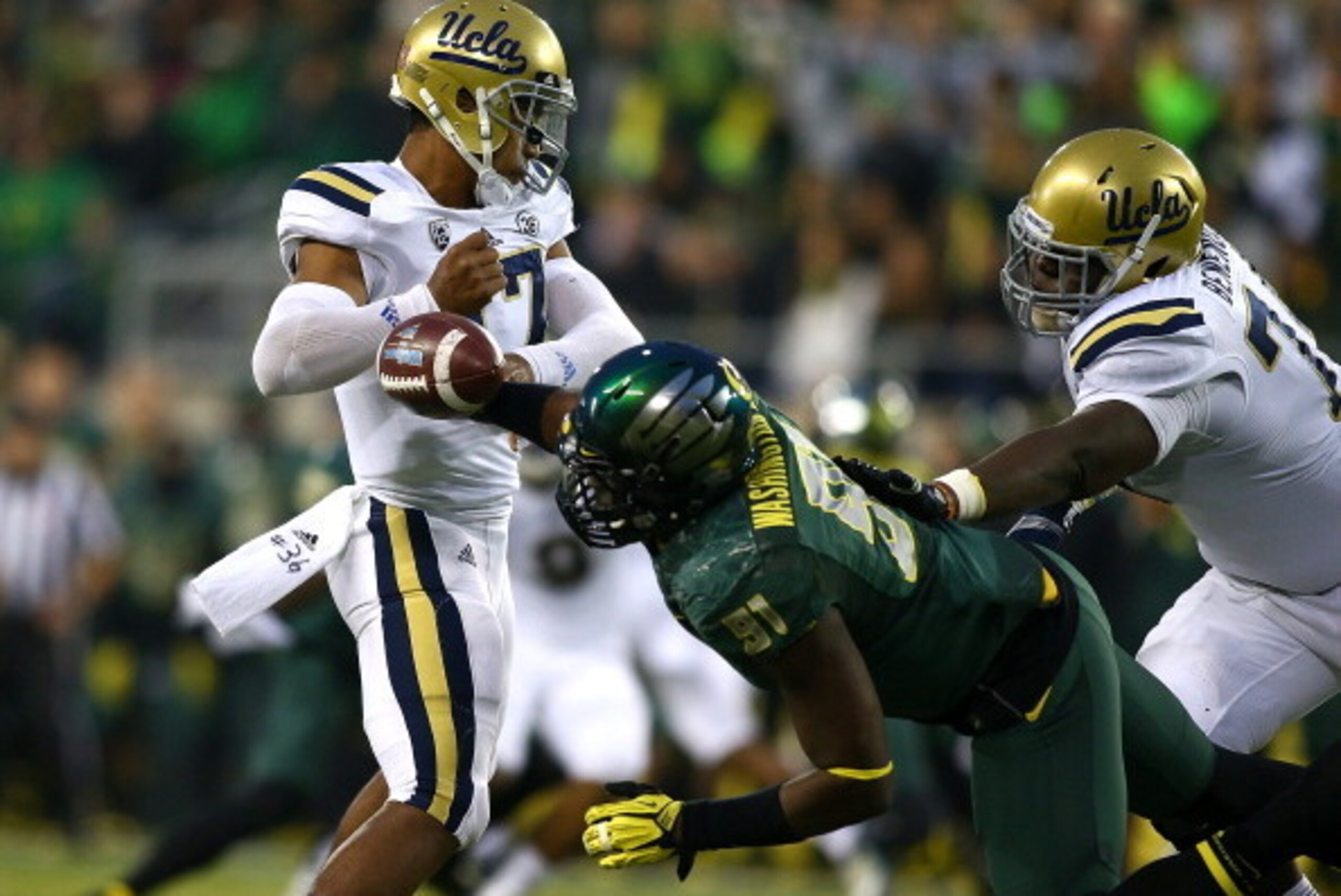 EUGENE, OR - OCTOBER 26:  Tony Washington #91 of the Oregon Ducks strips the ball from Brett Hundley #17 of the UCLA Bruins  on October 26, 2013 at the Autzen Stadium in Eugene, Oregon.  (Photo by Jonathan Ferrey/Getty Images)