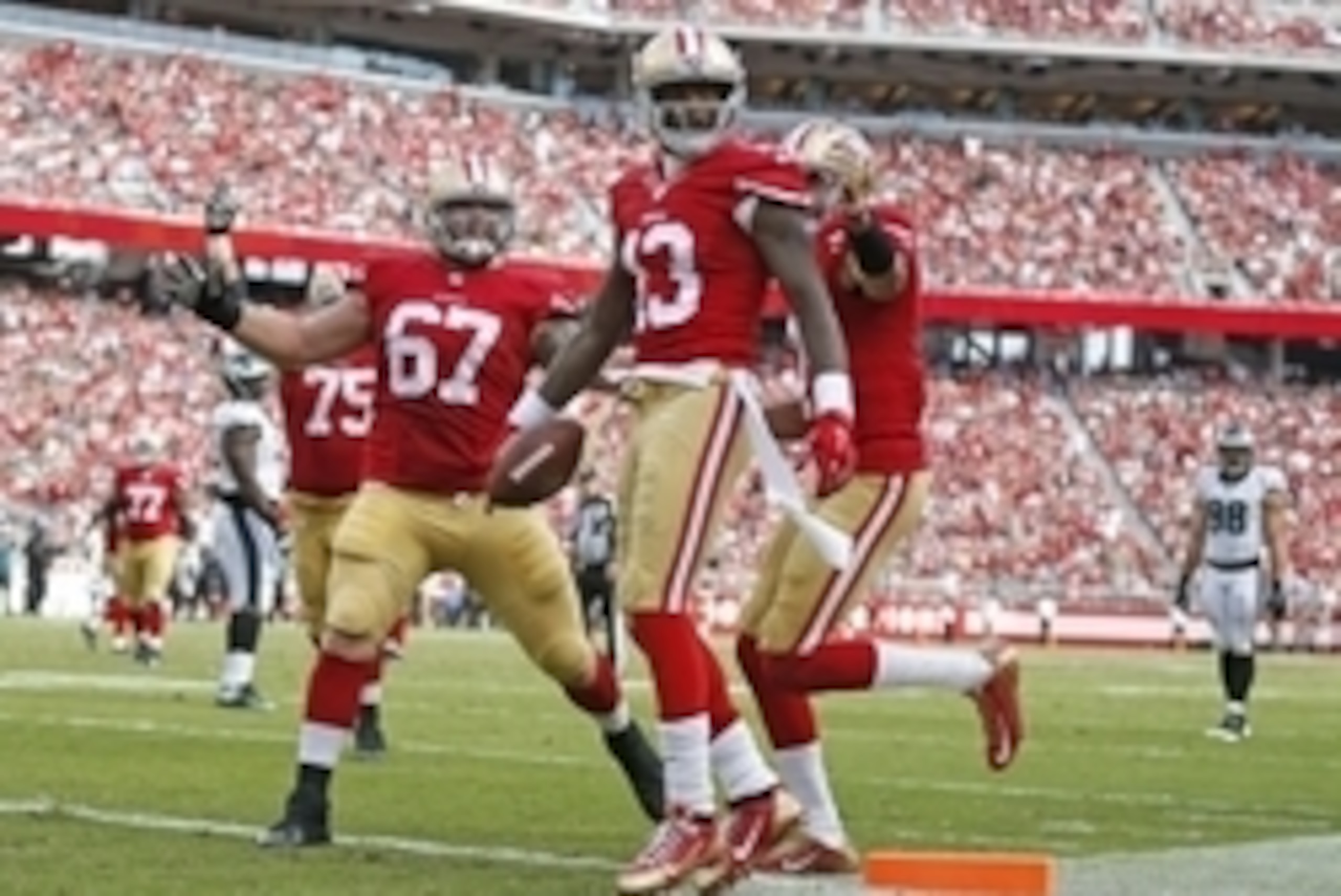 Sep 28, 2014; Santa Clara, CA, USA; San Francisco 49ers wide receiver Steve Johnson (13) congratulated by49ers center Daniel Kilgore (67) and other team mates after pulling a 12 yard touchdown pass from 49ers quarterback Colin Kaepernick (not pictured) du