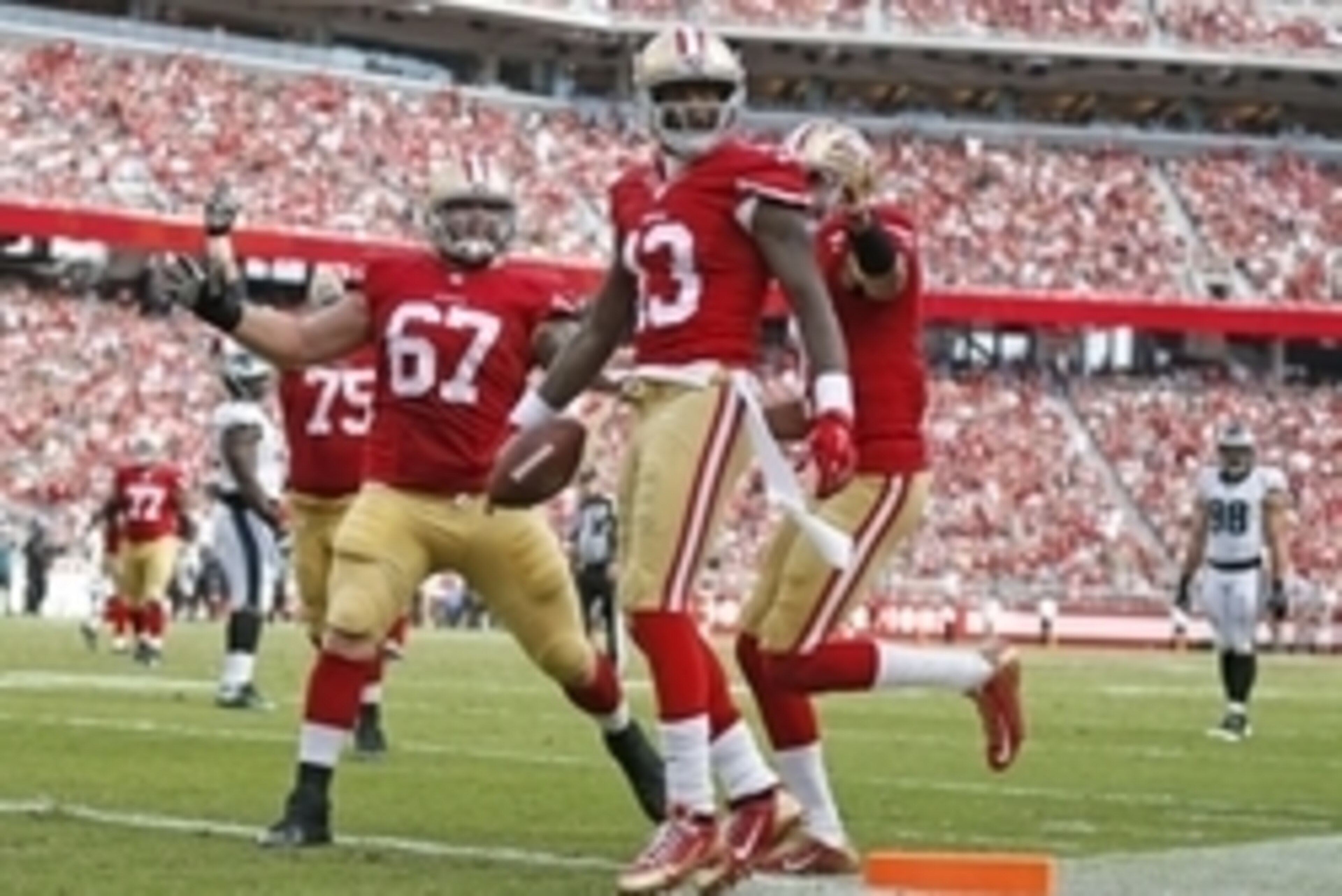Sep 28, 2014; Santa Clara, CA, USA; San Francisco 49ers wide receiver Steve Johnson (13) congratulated by49ers center Daniel Kilgore (67) and other team mates after pulling a 12 yard touchdown pass from 49ers quarterback Colin Kaepernick (not pictured) du