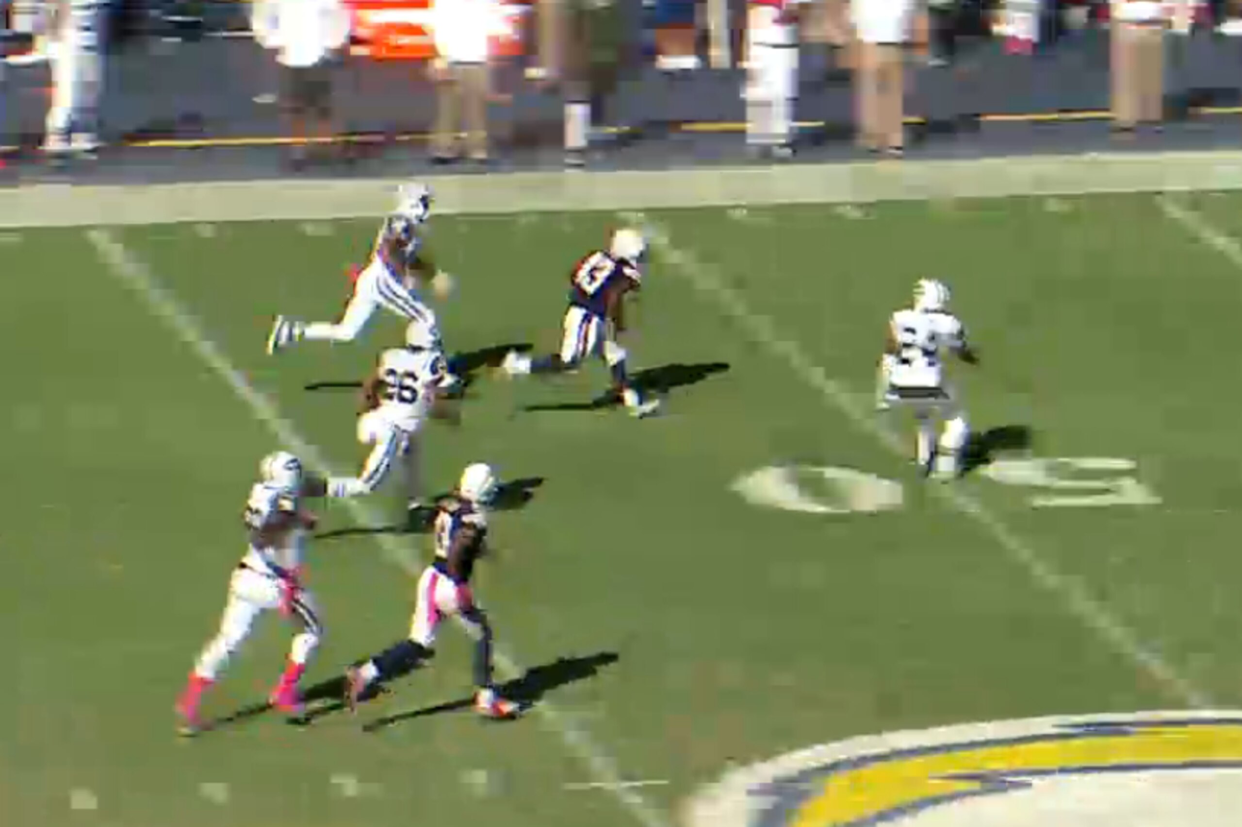After the stiff arm, Oliver has room to run. He uses his speed to gain extra yards in the open field.