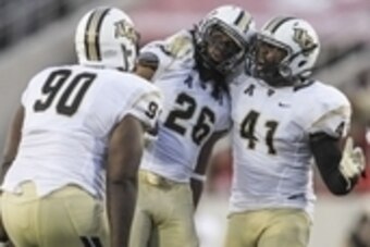 Oct 2, 2014; Houston, TX, USA; Central Florida Knights defensive back Clayton Geathers (26) is congratulated by linebacker Terrance Plummer (41) and defensive lineman Lance McDowdell (90) after making an interception during the second quarter against the 