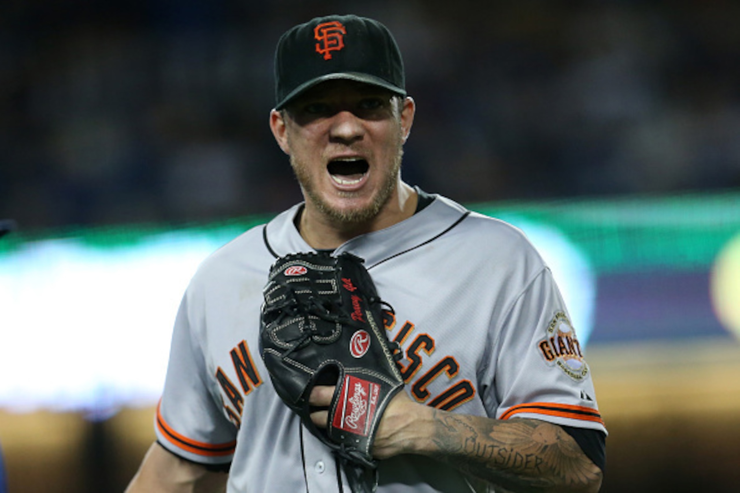 LOS ANGELES, CA - SEPTEMBER 22:  Starting pitcher Jake Peavy #22 of the San Francisco Giants shouts as he comes off the field after finishing a scoreless seventh inning against the Los Angeles Dodgers at Dodger Stadium on September 22, 2014 in Los Angeles