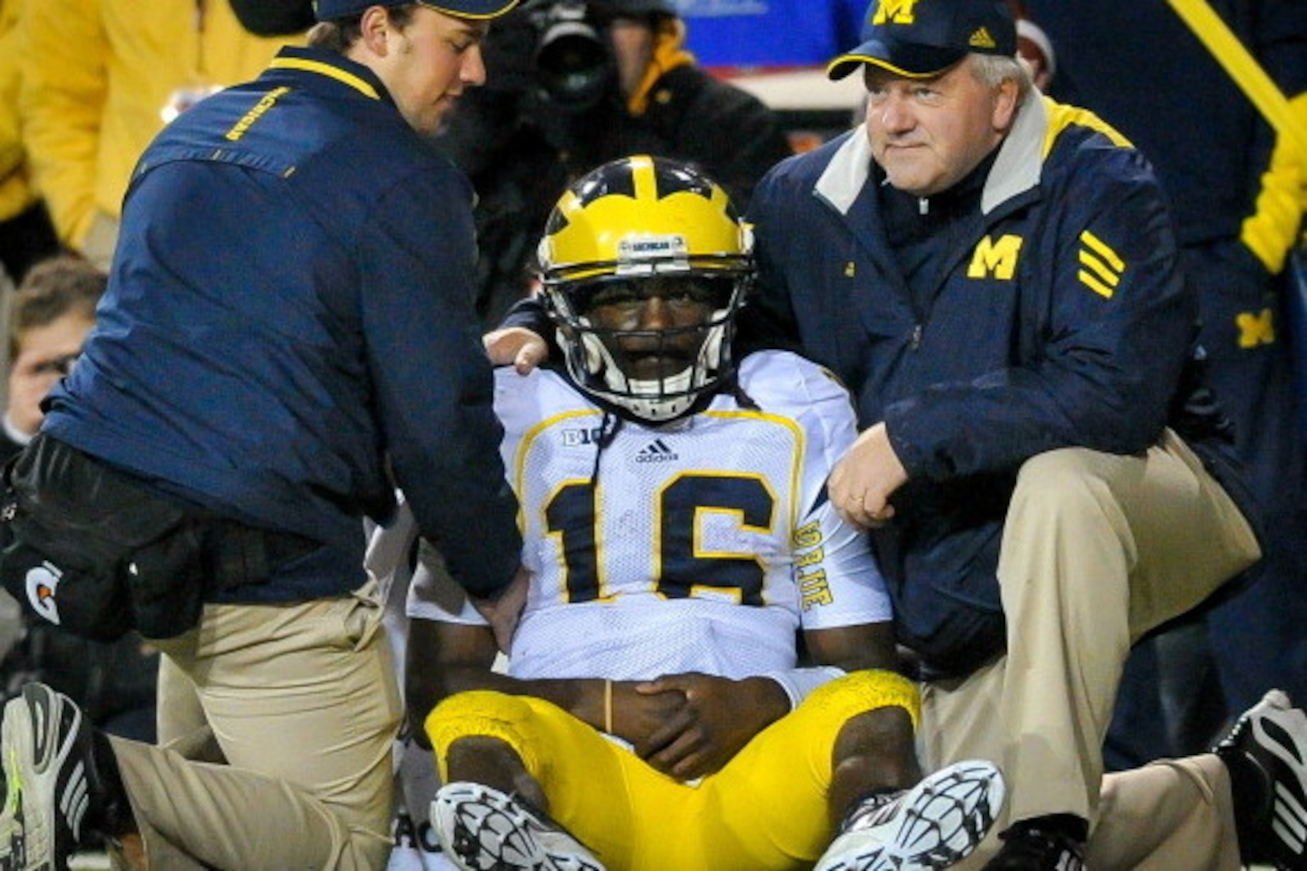 LINCOLN, NE - OCTOBER 27: Quarterback Denard Robinson #16 of the Michigan Wolverines is attended to by trainers after being injured during their game against the Nebraska Cornhuskers at Memorial Stadium on October 27, 2012 in Lincoln, Nebraska. (Photo by 