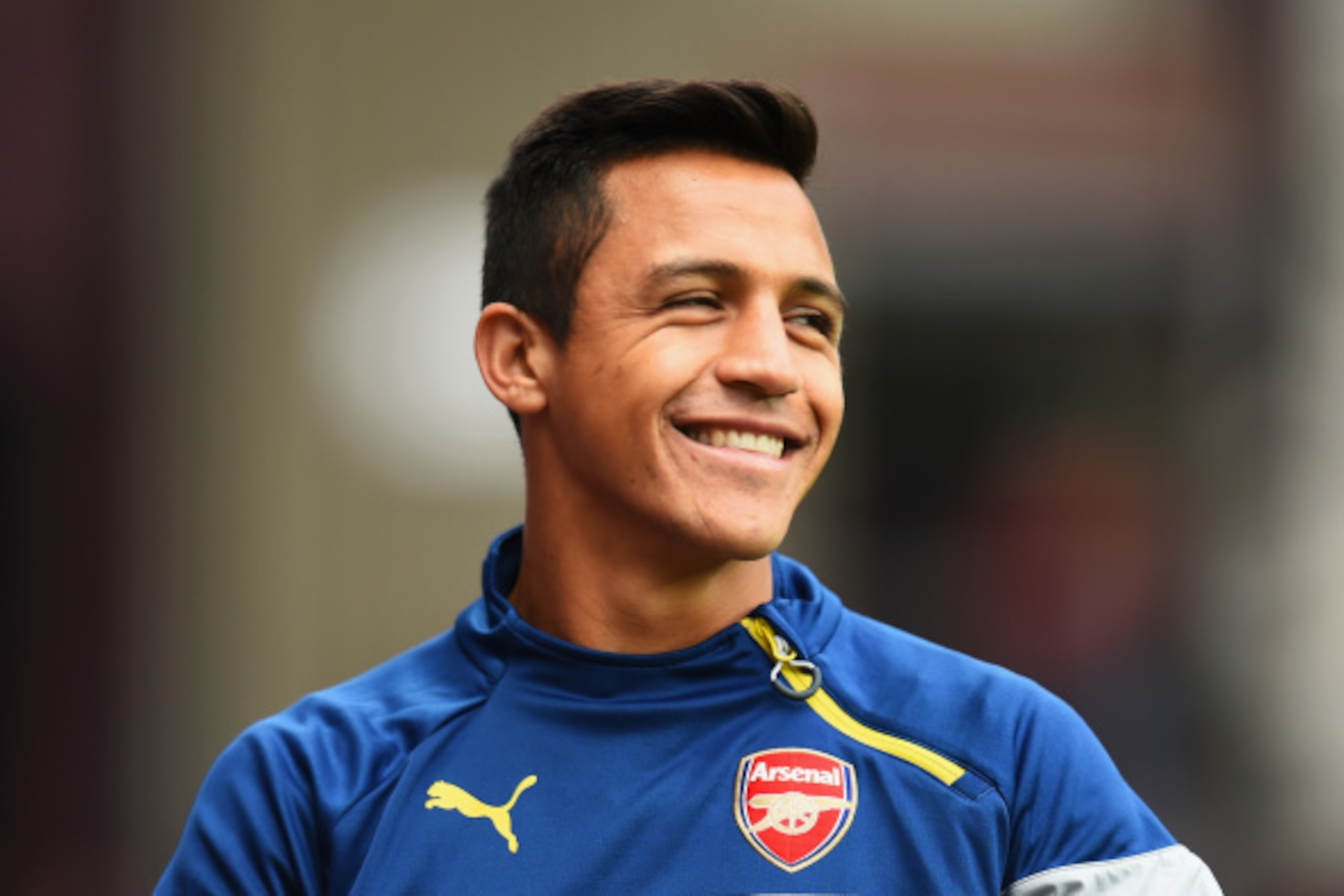 BIRMINGHAM, ENGLAND - SEPTEMBER 20: Alexis Sanchez of Arsenal smiles prior to the Barclays Premier League match between Aston Villa and Arsenal at Villa Park on September 20, 2014 in Birmingham, England.  (Photo by Shaun Botterill/Getty Images)