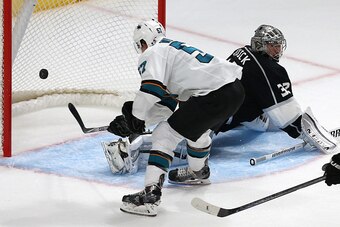 LOS ANGELES, CA - OCTOBER 08: Tommy Wingels #57 of the San Jose Sharks scores a goal past goalie Jonathan Quick #32 of the Los Angeles Kings in the second period of their NHL season opener at Staples Center on October 8, 2014 in Los Angeles, California.  