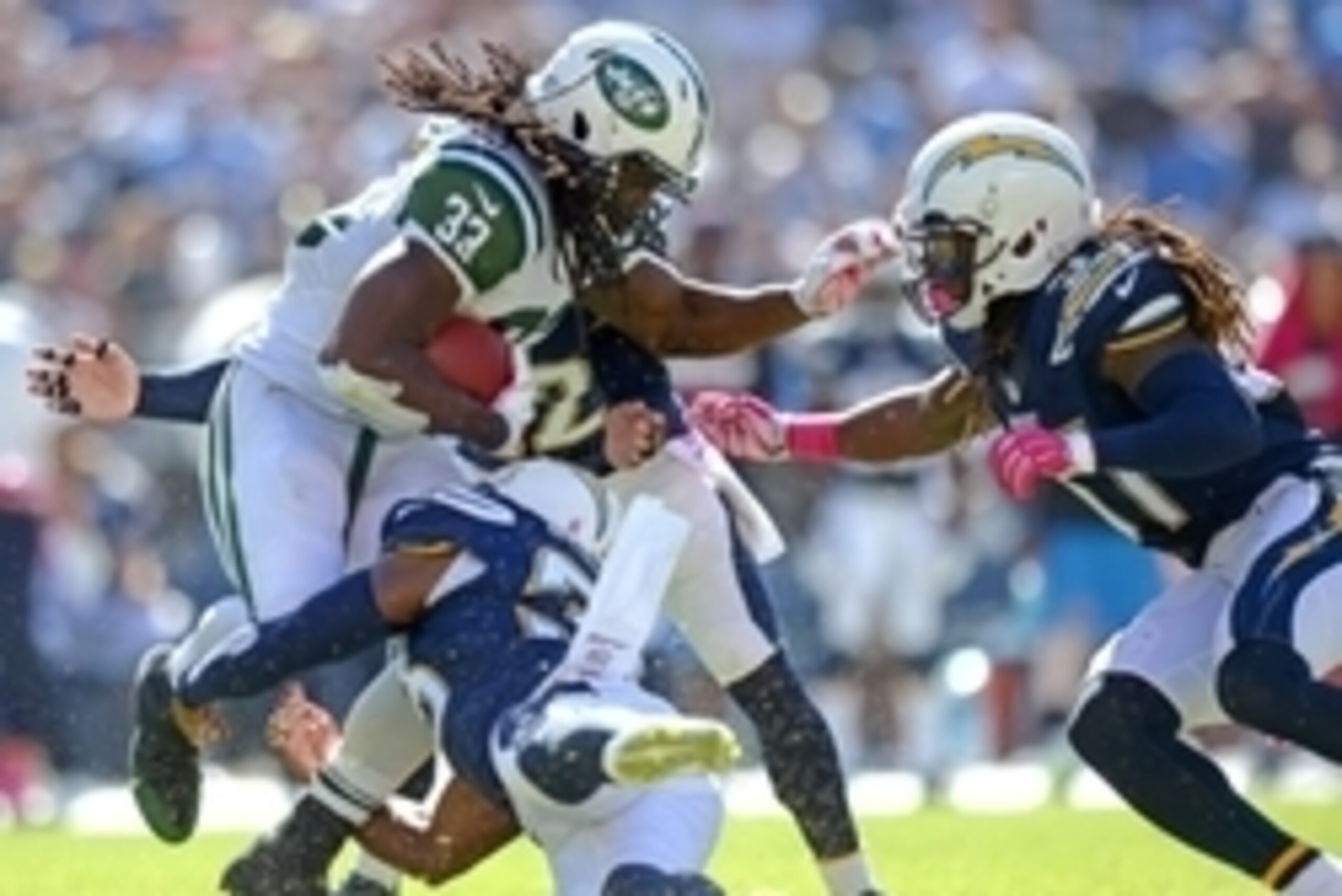 Oct 5, 2014; San Diego, CA, USA; New York Jets running back Chris Ivory (33) is stopped by San Diego Chargers free safety Eric Weddle (32) and strong safety Marcus Gilchrist (bottom) and defensive back Jahleel Addae (right) during the second quarter at Qu