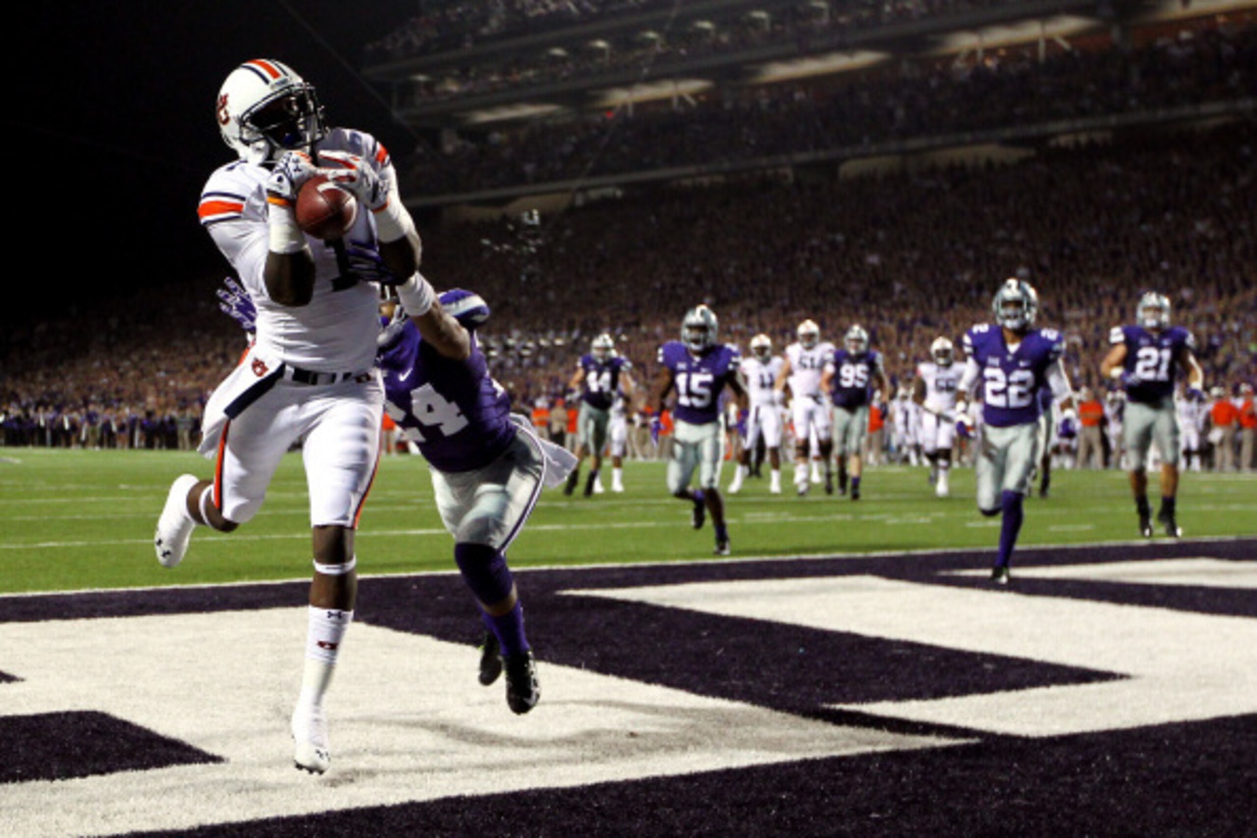 MANHATTAN, KS - SEPTEMBER 18:  Wide receiver D'haquille Williams #1 of the Auburn Tigers makes a catch in the endzone for a touchdown as defensive back Nate Jackson #24 of the Kansas State Wildcats defends during the game at Bill Snyder Family Football St