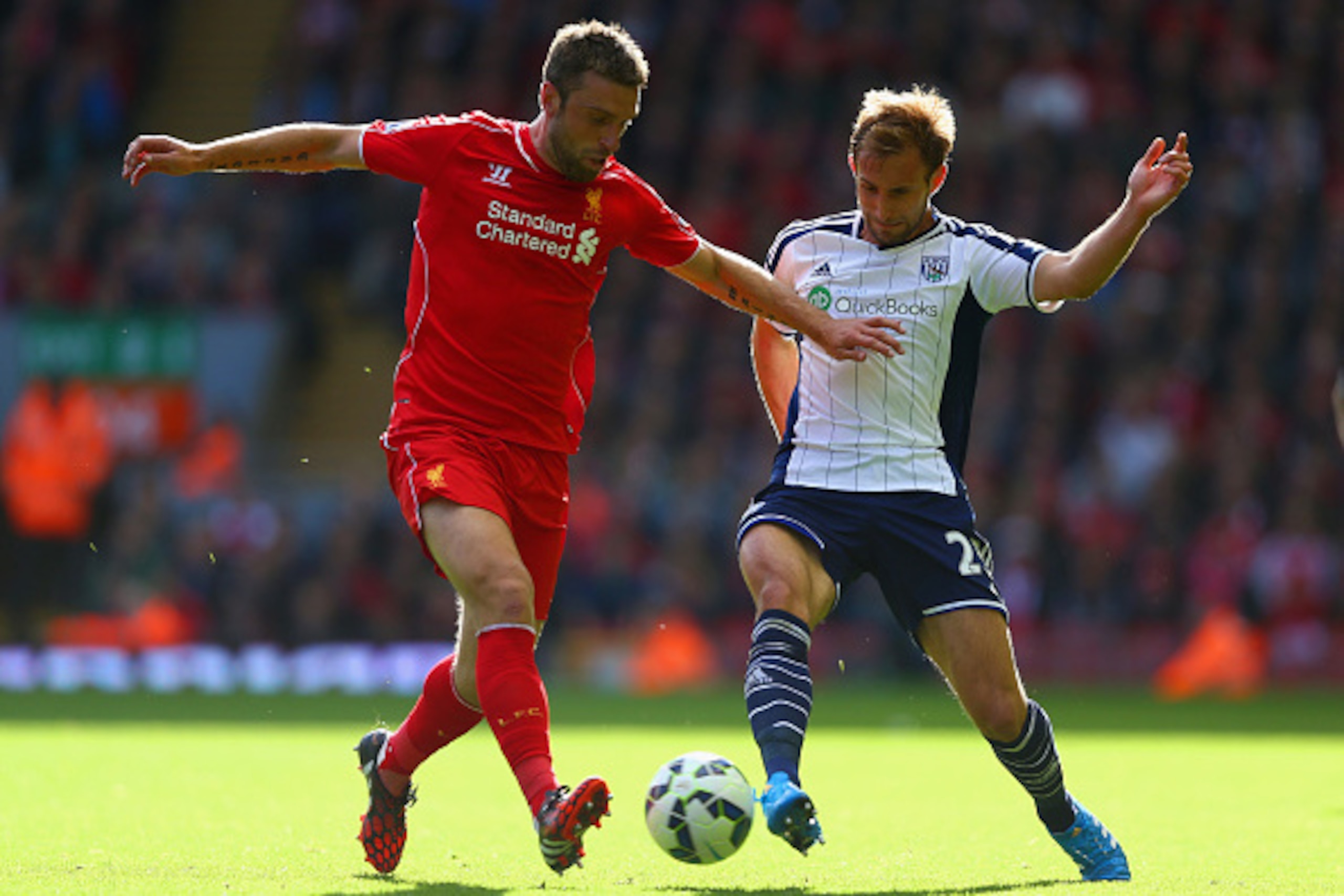 LIVERPOOL, ENGLAND - OCTOBER 04:  Rickie Lambert of Liverpool and Craig Dawson of West Brom battle for the ball during the Barclays Premier League match between Liverpool and West Bromwich Albion at Anfield on October 4, 2014 in Liverpool, England.  (Phot