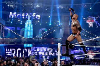 The Rock holds up the WWE title at WrestleMania 29.