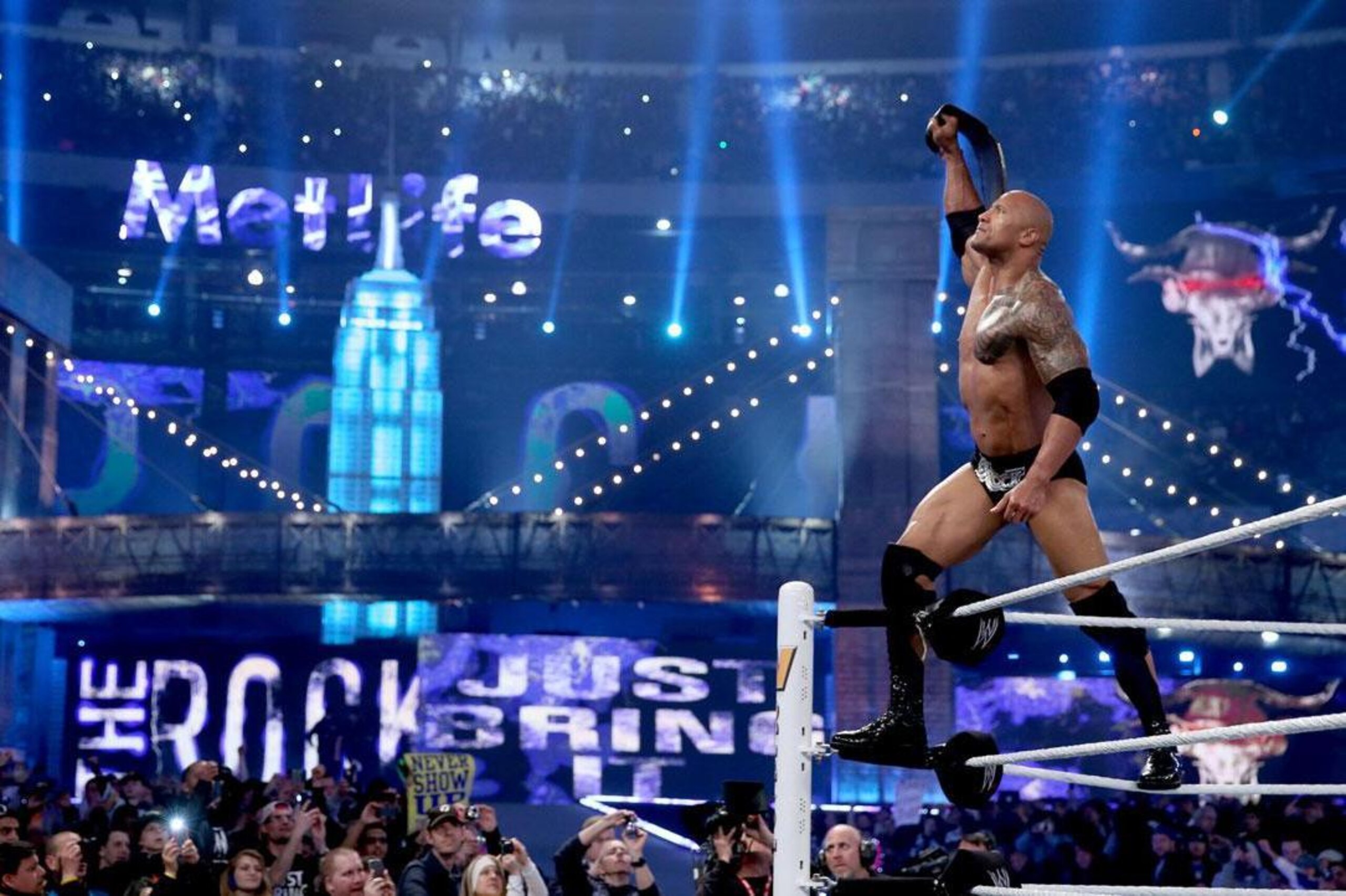 The Rock holds up the WWE title at WrestleMania 29.