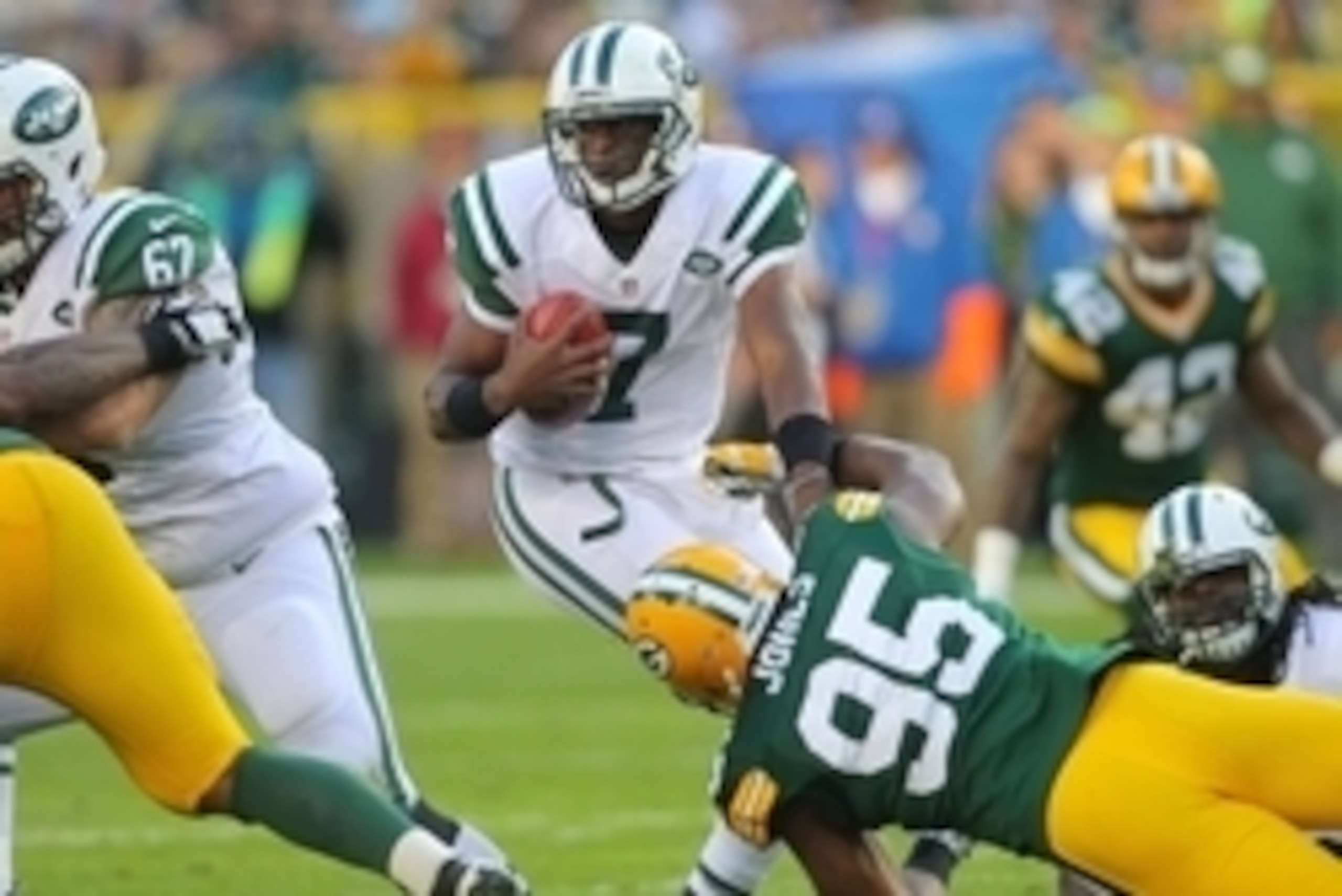 Sep 14, 2014; Green Bay, WI, USA; New York Jets quarterback Geno Smith (7) evades a tackle by Green Bay Packers defensive end Datone Jones (95) during the second half of a game at Lambeau Field. Green Bay won 31-24. Mandatory Credit: Dennis Wierzbicki-USA Sep 14, 2014; Green Bay, WI, USA; New York Jets quarterback Geno Smith (7) evades a tackle by Green Bay Packers defensive end Datone Jones (95) during the second half of a game at Lambeau Field. Green Bay won 31-24. Mandatory Credit: Dennis Wierzbicki-USA