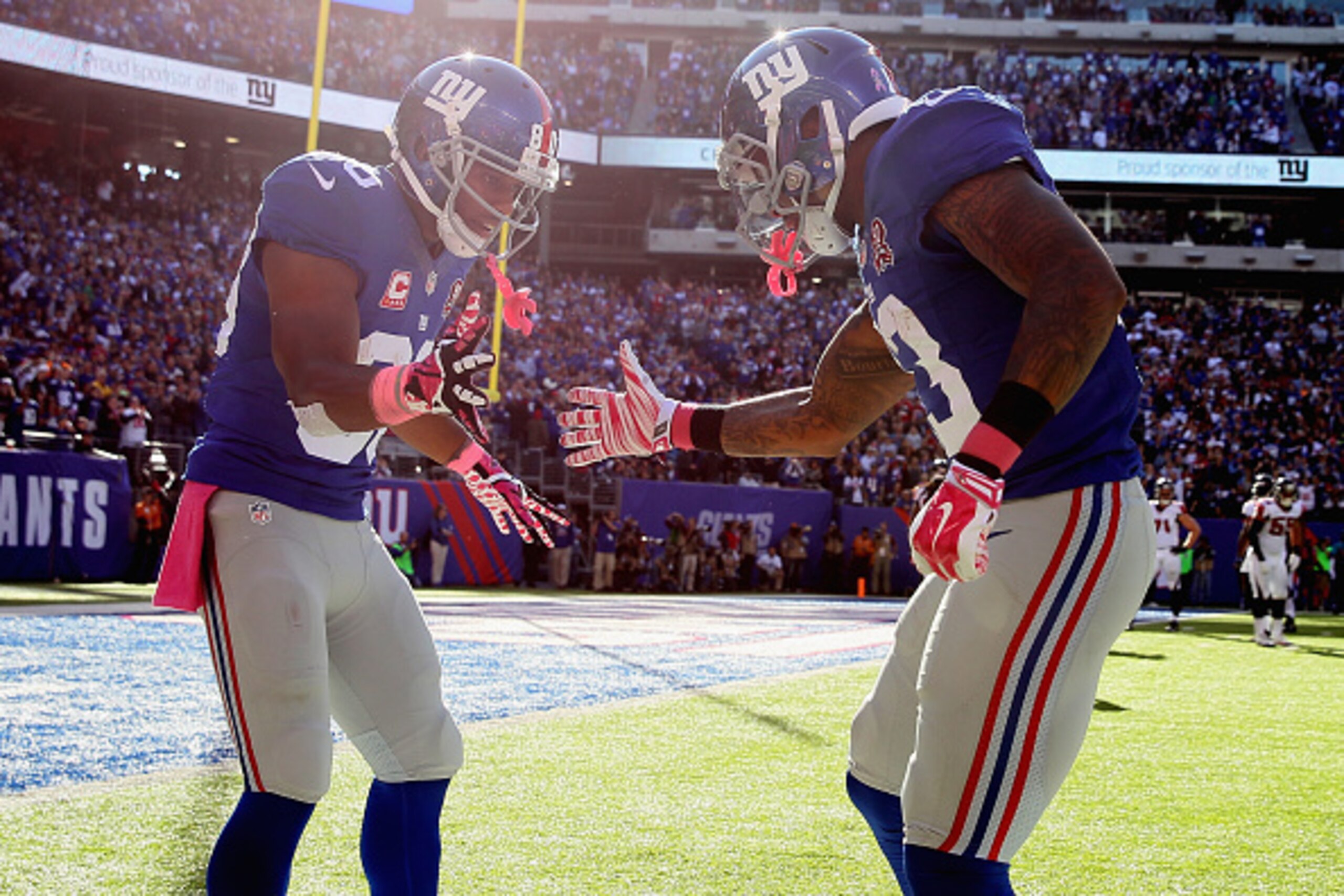 EAST RUTHERFORD, NJ - OCTOBER 05:  Wide receiver Odell Beckham #13 of the New York Giants celebrates with wide receiver Victor Cruz #80 after scoring a 15 yard touchdown in the fourth quarter against the Atlanta Falcons during their game at MetLife Stadiu