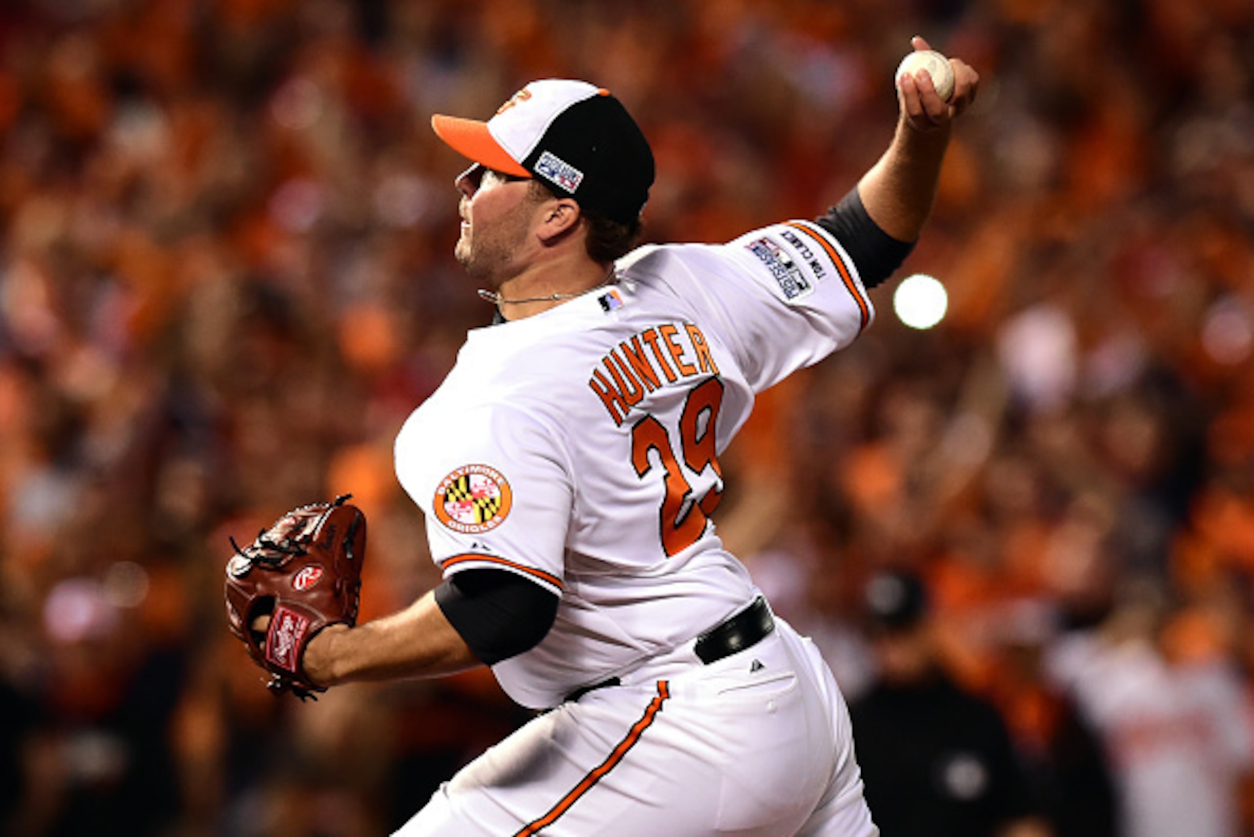 BALTIMORE, MD - OCTOBER 02:  Tommy Hunter #29 of the Baltimore Orioles throws a pitch in the eighth inning against the Detroit Tigers during Game One of the American League Division Series at Oriole Park at Camden Yards on October 2, 2014 in Baltimore, Ma