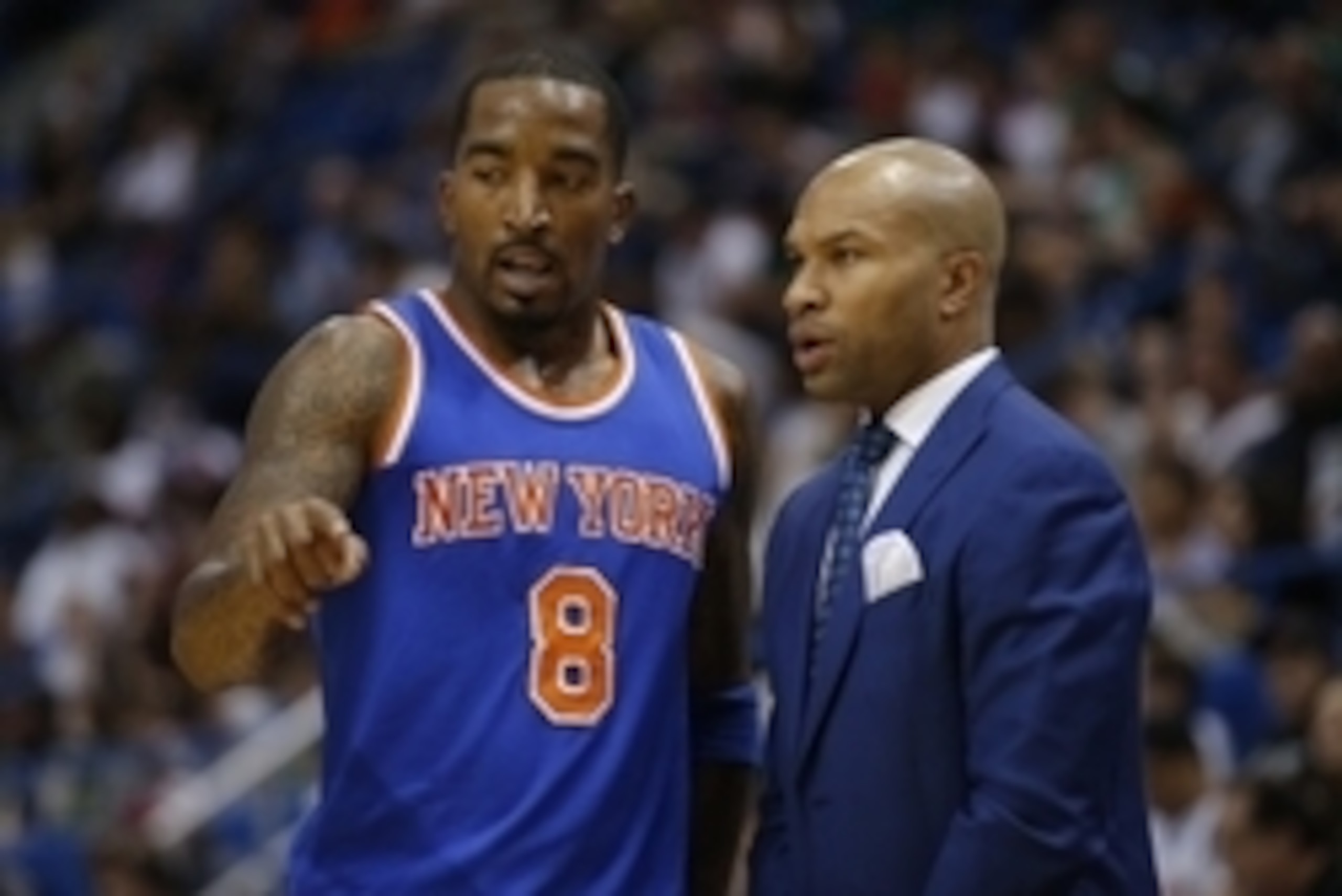 Oct 8, 2014; Hartford, CT, USA; New York Knicks head coach Derek Fisher (right) talks with guard J.R. Smith (8) during a break in the action against the Boston Celtics in the second half at XL Center. The Celtics defeated the New York Knicks 106-86. Manda