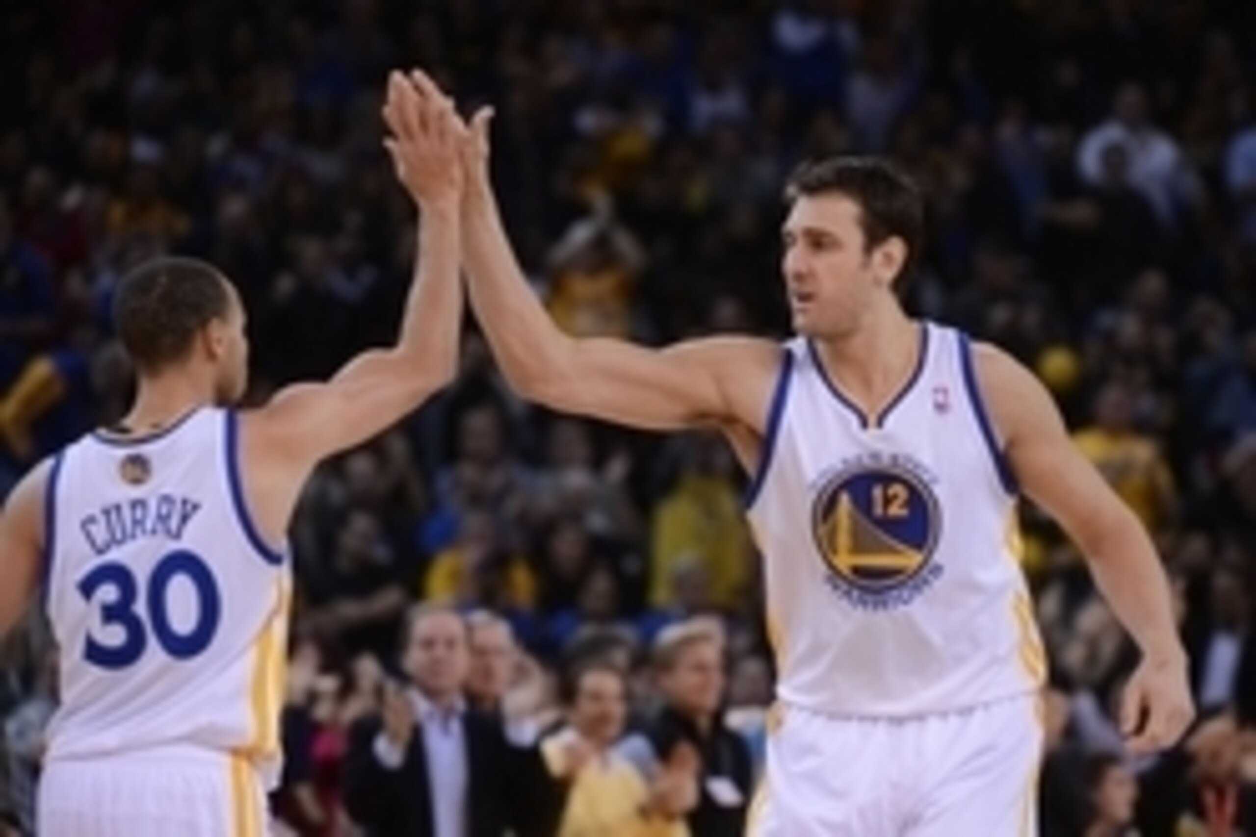 December 11, 2013; Oakland, CA, USA; Golden State Warriors center Andrew Bogut (12) celebrates with point guard Stephen Curry (30) during the fourth quarter against the Dallas Mavericks at Oracle Arena. The Warriors defeated the Mavericks 95-93. Mandatory December 11, 2013; Oakland, CA, USA; Golden State Warriors center Andrew Bogut (12) celebrates with point guard Stephen Curry (30) during the fourth quarter against the Dallas Mavericks at Oracle Arena. The Warriors defeated the Mavericks 95-93. Mandatory