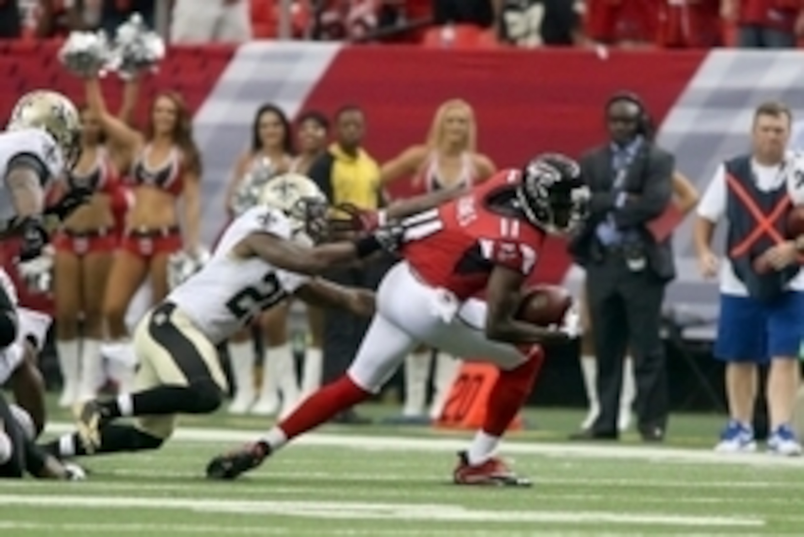 Sep 7, 2014; Atlanta, GA, USA; Atlanta Falcons wide receiver Julio Jones (11) tries to get away from the defense of New Orleans Saints free safety Rafael Bush (25) after a catch in their game at the Georgia Dome. The Falcons won 37-34 in overtime. Mandato