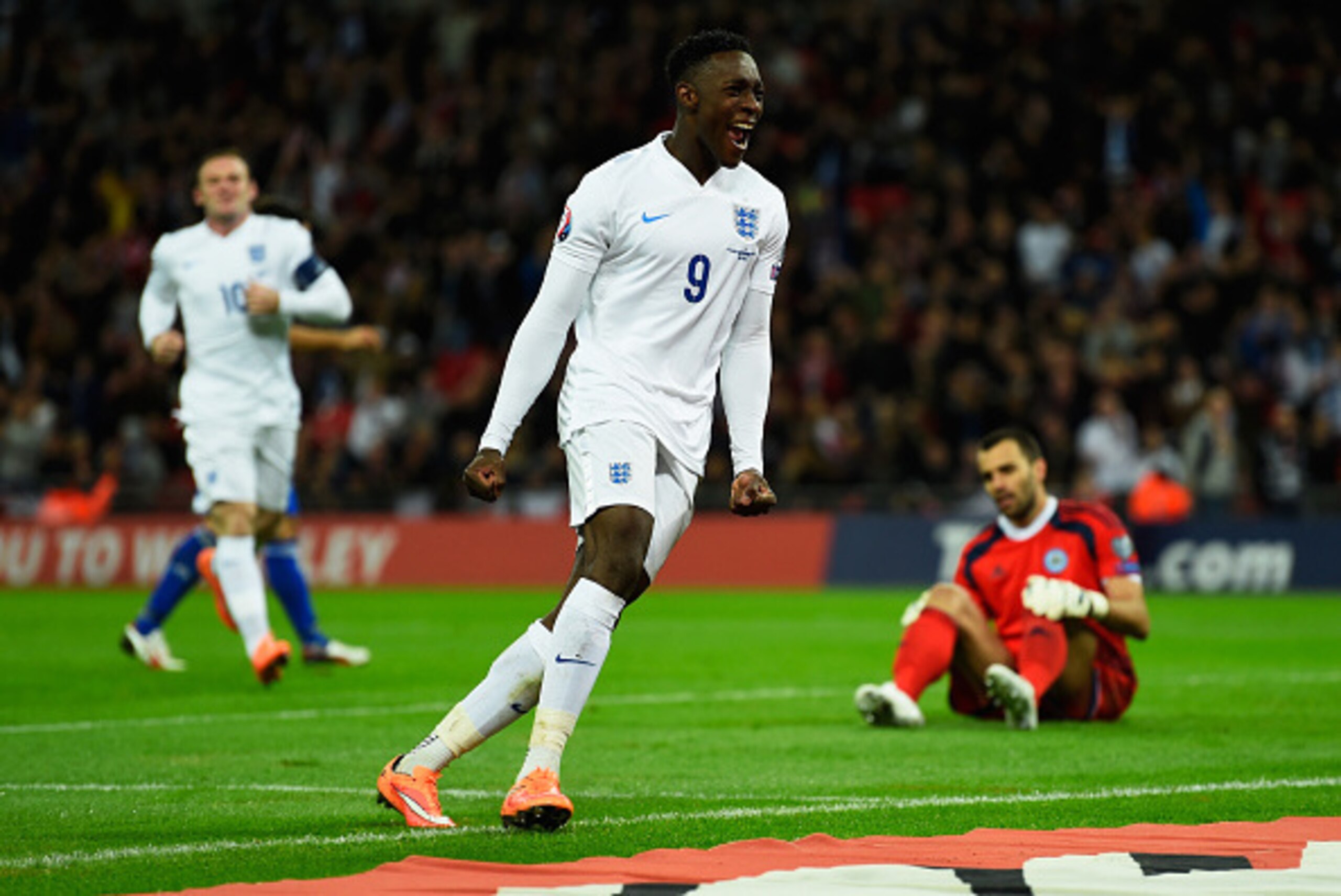 LONDON, ENGLAND - OCTOBER 09:  Danny Welbeck of England celebrates scoring their third goal as goalkeeper Aldo Simoncini of San Marino looks dejected during the EURO 2016 Group E Qualifying match between England and San Marino at Wembley Stadium on Octobe