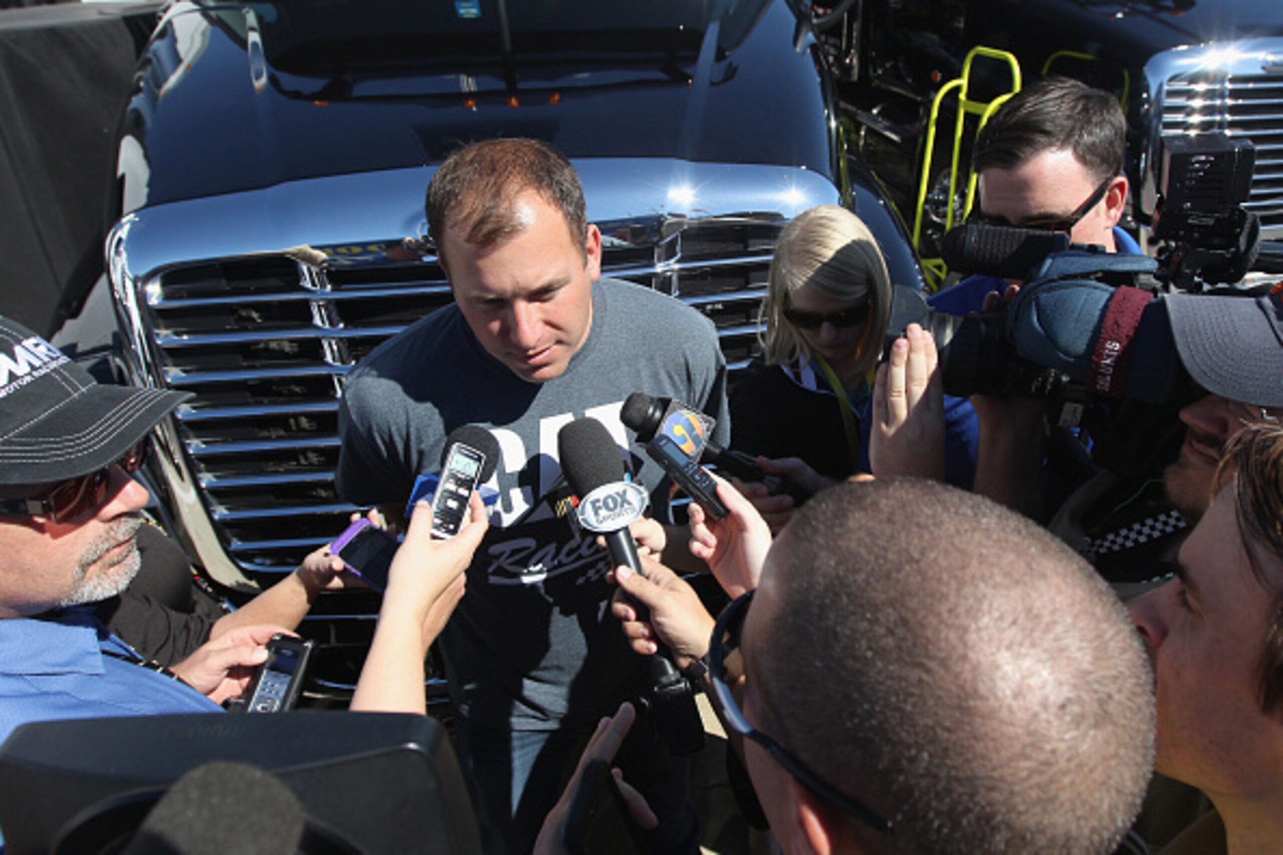 CHARLOTTE, NC - OCTOBER 09:  Ryan Newman, driver of the #31 Caterpillar Chevrolet, speaks with the media during a press conference in the garage area prior to practice for the NASCAR Sprint Cup Series Bank of America 500 at Charlotte Motor Speedway on Oct