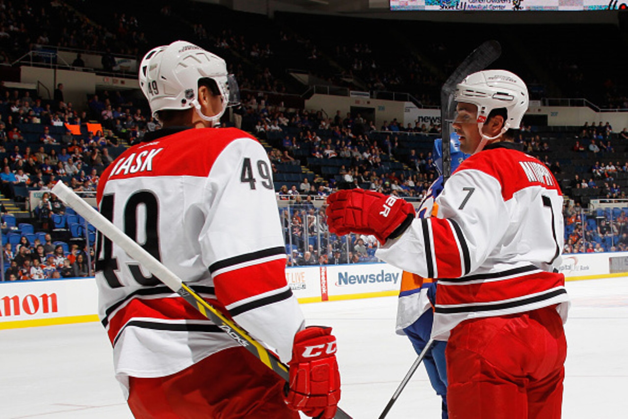 UNIONDALE, NY - SEPTEMBER 24: Ryan Murphy #7 of the Carolina Hurricanes (L) celebrates his first period power play goal against the New York Islanders along with Victor Rask #49 (R) at the Nassau Veterans Memorial Coliseum on September 24, 2014 in Unionda