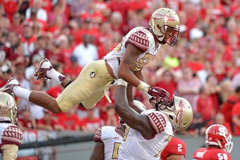 RALEIGH, NC - SEPTEMBER 27:  Rashad Greene #80 of the Florida State Seminoles celebrates with teammates after scoring a touchdown against the North Carolina State Wolfpack during their game at Carter-Finley Stadium on September 27, 2014 in Raleigh, North 