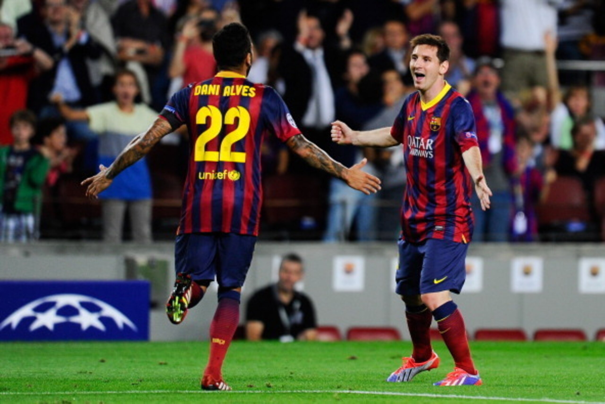 BARCELONA, SPAIN - SEPTEMBER 18:  Lionel Messi (R) of FC Barcelona celebrates with his team-mate Dani Alves after scoring the opening goal during the UEFA Champions League Group H match between FC Barcelona and Ajax Amsterdam at the Camp Nou stadium on Se