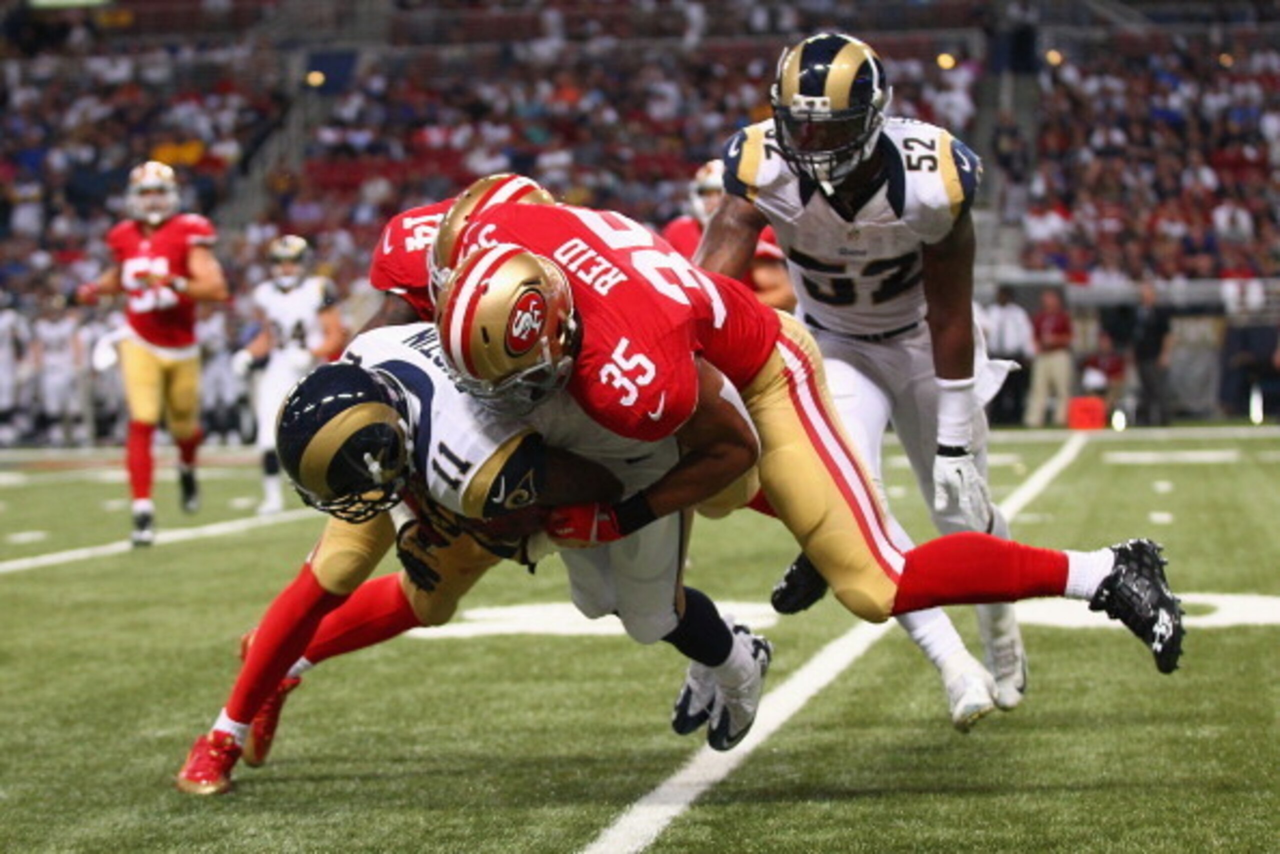 ST. LOUIS, MO - SEPTEMBER 26: Tavon Austin #11 of the St. Louis Rams is tackled by Eric Reid #35 of the St. Louis Rams during a kick return at the Edward Jones Dome on September 26, 2013 in St. Louis, Missouri.  The 49ers baet the rams 35-11.  (Photo by D