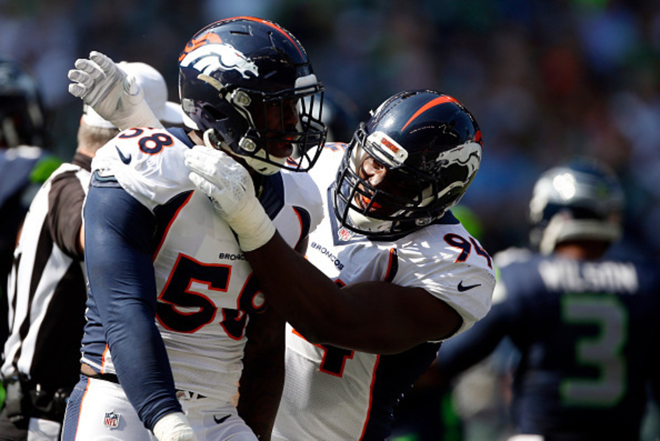 SEATTLE, WA - SEPTEMBER 21: Outside linebacker Von Miller #58 of the Denver Broncos celebrates with defensive end DeMarcus Ware #94 of the Denver Bronco after making a play during the second quarter of the game against the Seattle Seahawks at CenturyLink 