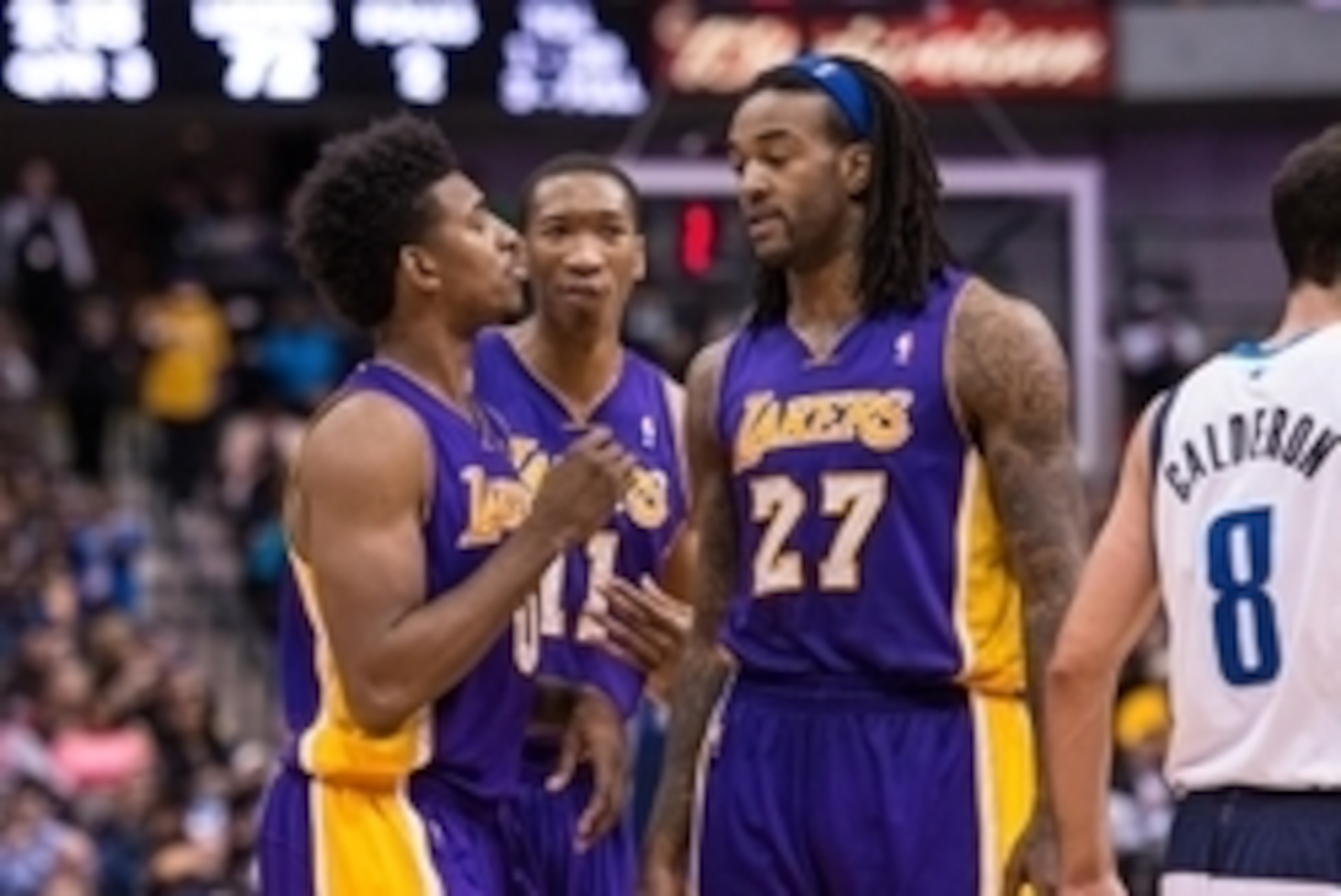 Jan 7, 2014; Dallas, TX, USA; Los Angeles Lakers small forward Nick Young (0) and shooting guard Wesley Johnson (11) and center Jordan Hill (27) wait for play to resume against the Dallas Mavericks during the game at the American Airlines Center. The Mave