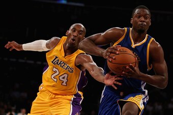 LOS ANGELES, CA - OCTOBER 09:  Kobe Bryant #24 of the Los Angeles Lakers attempts to steal the ball from Harrison Barnes #40 of the Golden State Warriors in the second half at Staples Center on October 9, 2014 in Los Angeles, California. The Warriors defe