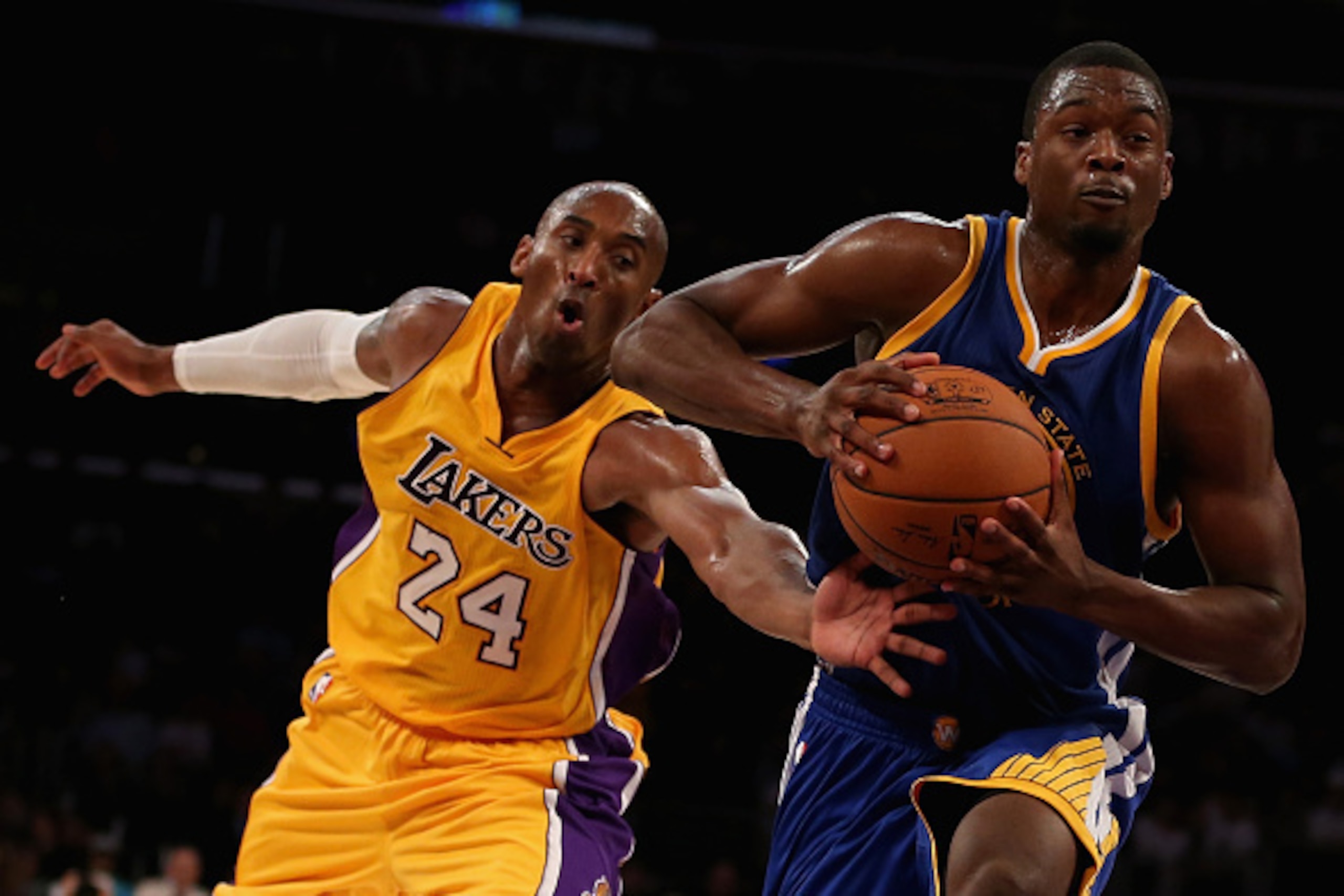 LOS ANGELES, CA - OCTOBER 09:  Kobe Bryant #24 of the Los Angeles Lakers attempts to steal the ball from Harrison Barnes #40 of the Golden State Warriors in the second half at Staples Center on October 9, 2014 in Los Angeles, California. The Warriors defe