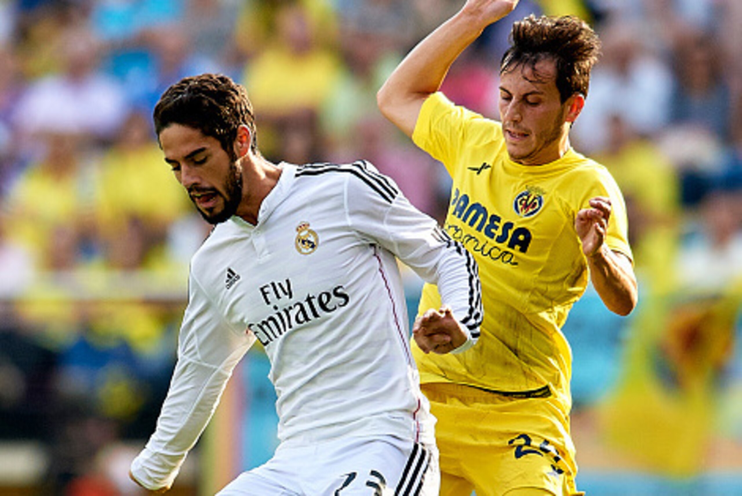 VILLARREAL, SPAIN - SEPTEMBER 27:  Isco (L) of Real Madrid is tackled by Gerard Moreno during the La Liga match between Villarreal CF and Real Madrid at El Madrigal on September 27, 2014 in Villarreal, Spain.  (Photo by Manuel Queimadelos Alonso/Getty Ima