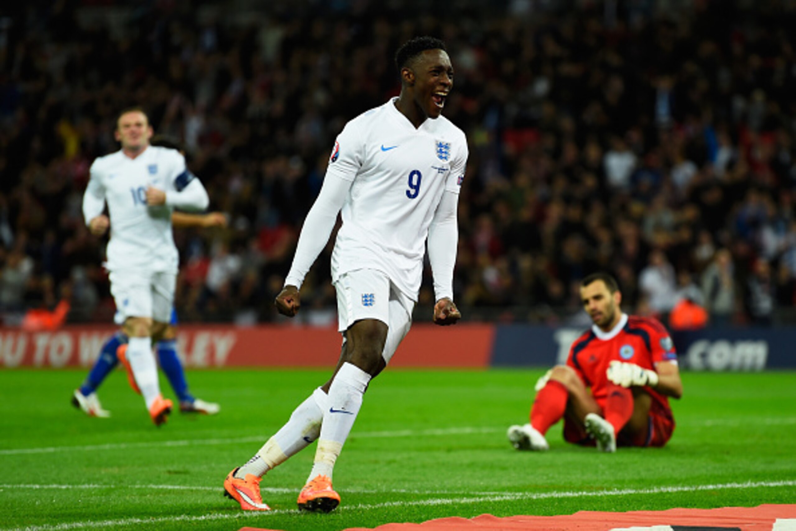 LONDON, ENGLAND - OCTOBER 09:  Danny Welbeck of England celebrates scoring their third goal as goalkeeper Aldo Simoncini of San Marino looks dejected during the EURO 2016 Group E Qualifying match between England and San Marino at Wembley Stadium on Octobe