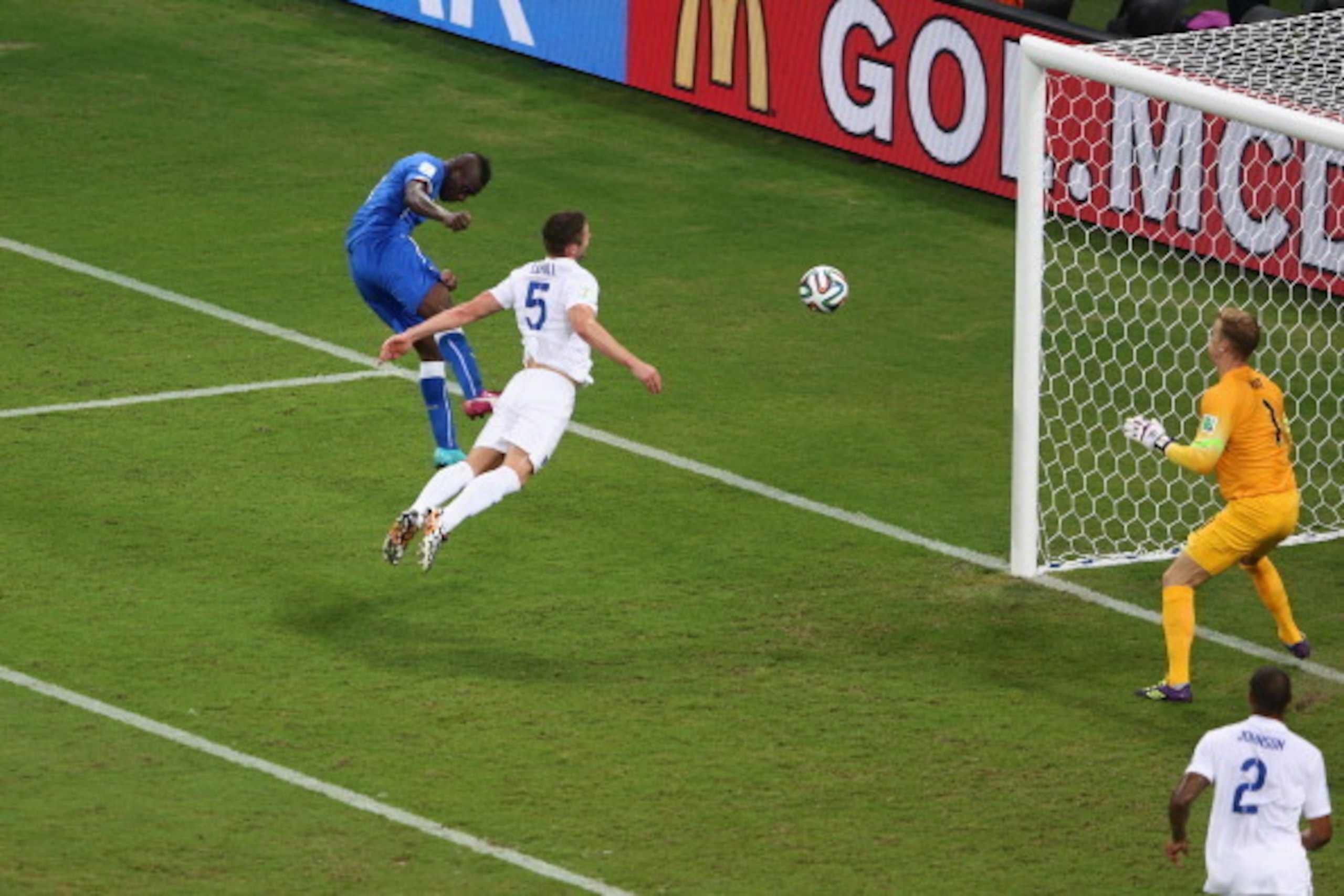MANAUS, BRAZIL - JUNE 14:  Mario Balotelli of Italy scores his team's second goal on a header past Gary Cahill and goalkeeper Joe Hart of England during the 2014 FIFA World Cup Brazil Group D match between England and Italy at Arena Amazonia on June 14, 2