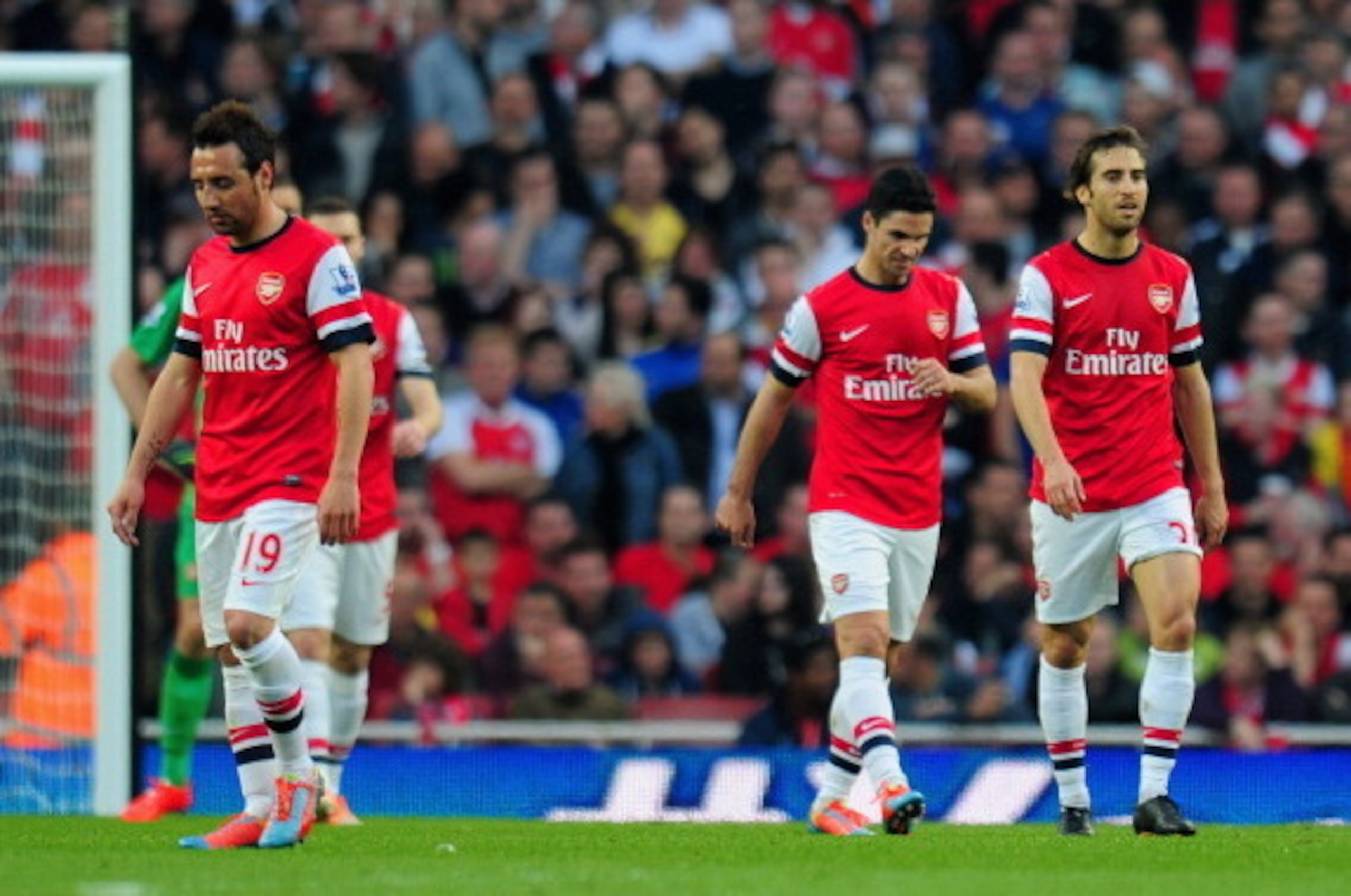 LONDON, ENGLAND - MARCH 29:  A dejected Santi Cazorla, Mikel Arteta and Mathieu Flamini of Arsenal after conceding the first goal during the Barclays Premier League match between Arsenal and Manchester City at Emirates Stadium on March 29, 2014 in London,