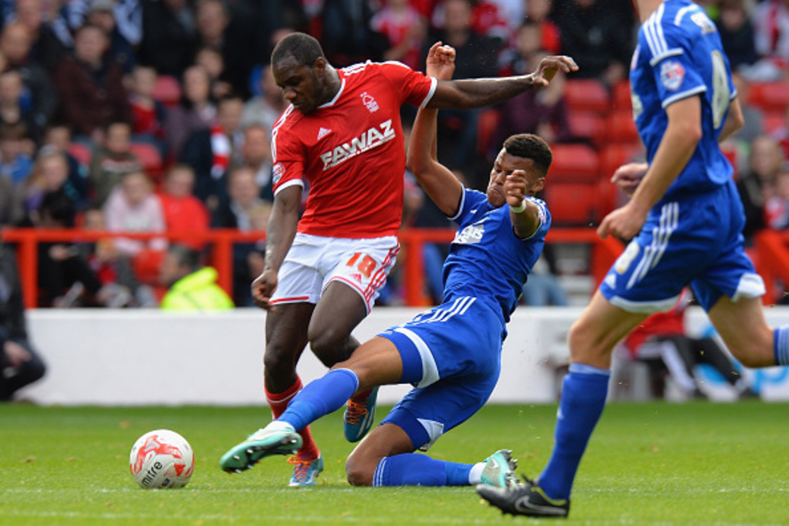 NOTTINGHAM, ENGLAND - OCTOBER 05:  Michail Antonio of Nottingham Forest is tackled by Tyrone Mings of Ipswich Town during the Sky Bet Championship match between Nottingham Forest and Ipswich Town at City Ground on October 5, 2014 in Nottingham, England.  