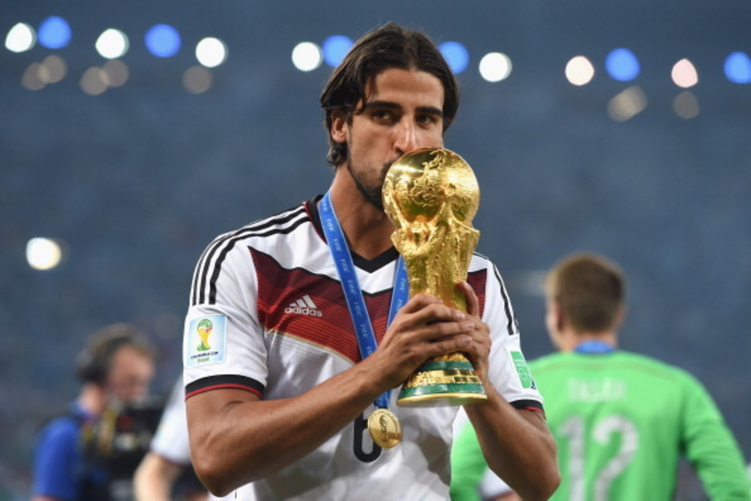 RIO DE JANEIRO, BRAZIL - JULY 13:  Sami Khedira of Germany kisses the World Cup trophy  after defeating Argentina 1-0 in extra time during the 2014 FIFA World Cup Brazil Final match between Germany and Argentina at Maracana on July 13, 2014 in Rio de Jane
