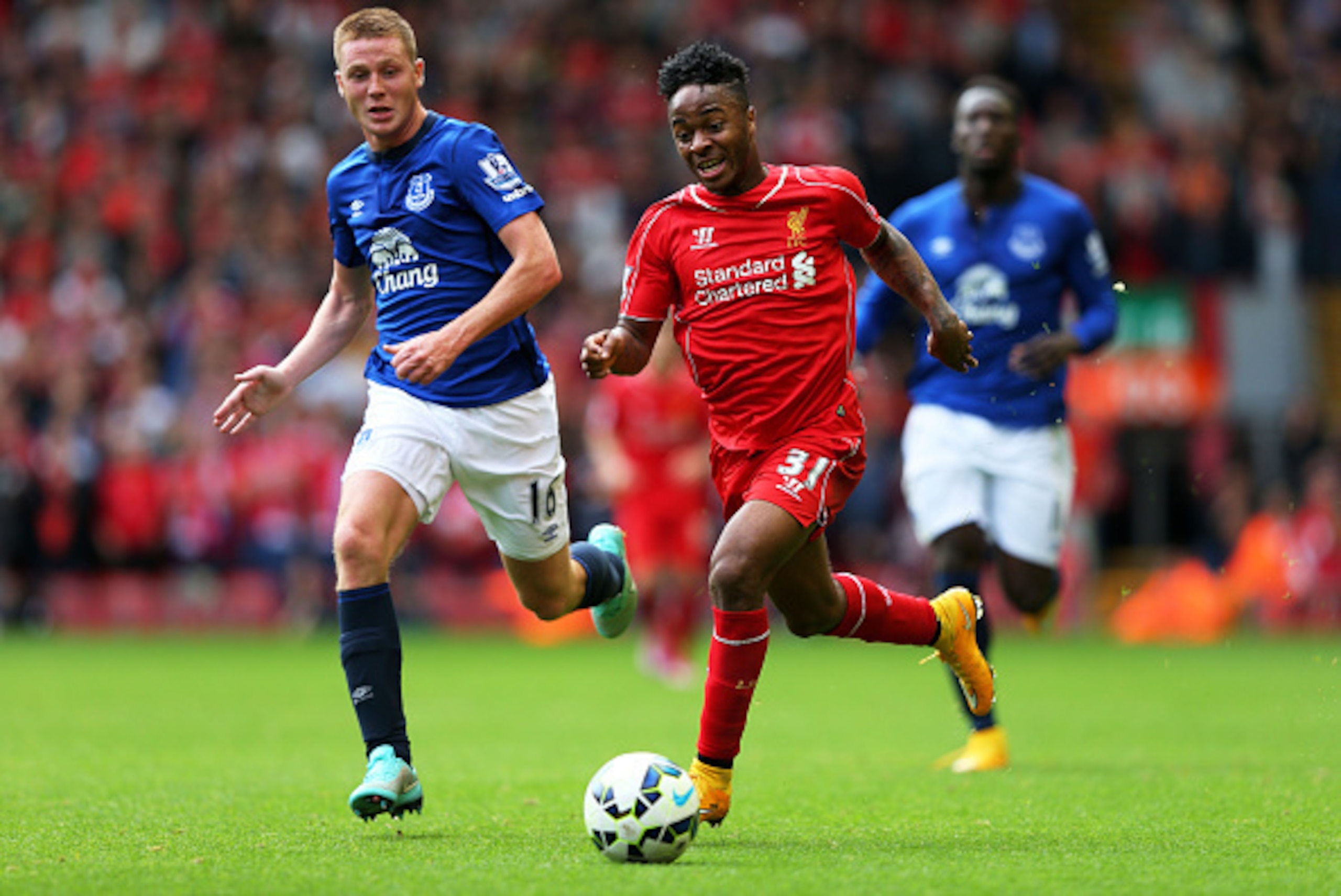 LIVERPOOL, ENGLAND - SEPTEMBER 27:  Raheem Sterling of Liverpool is pursued by James McCarthy of Everton during the Barclays Premier League match between Liverpool and Everton at Anfield on September 27, 2014 in Liverpool, England.  (Photo by Alex Livesey