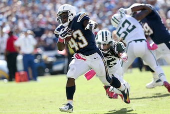 SAN DIEGO, CA - OCTOBER 05:  Running back Branden Oliver #43 of the San Diego Chargers carries the ball past safety Calvin Pryor #25 of the New York Jets on a 15 yard touchdown run in the second quarter at Qualcomm Stadium on October 5, 2014 in San Diego,