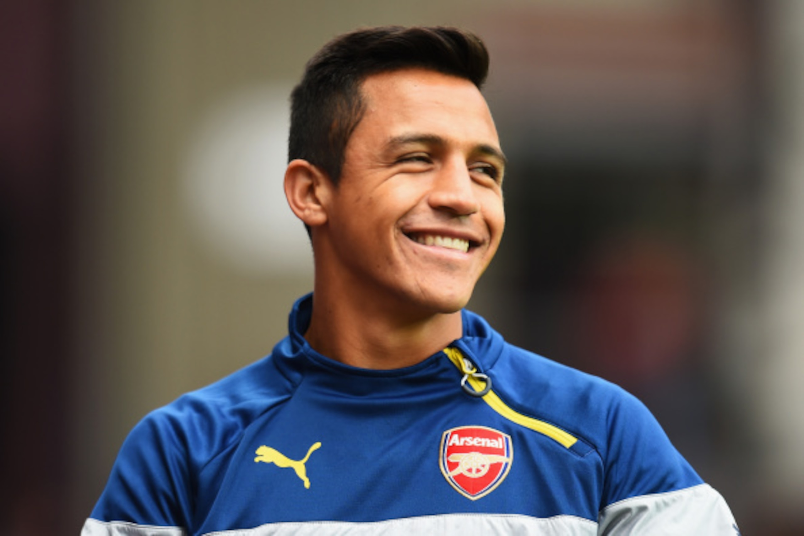 BIRMINGHAM, ENGLAND - SEPTEMBER 20: Alexis Sanchez of Arsenal smiles prior to the Barclays Premier League match between Aston Villa and Arsenal at Villa Park on September 20, 2014 in Birmingham, England.  (Photo by Shaun Botterill/Getty Images)