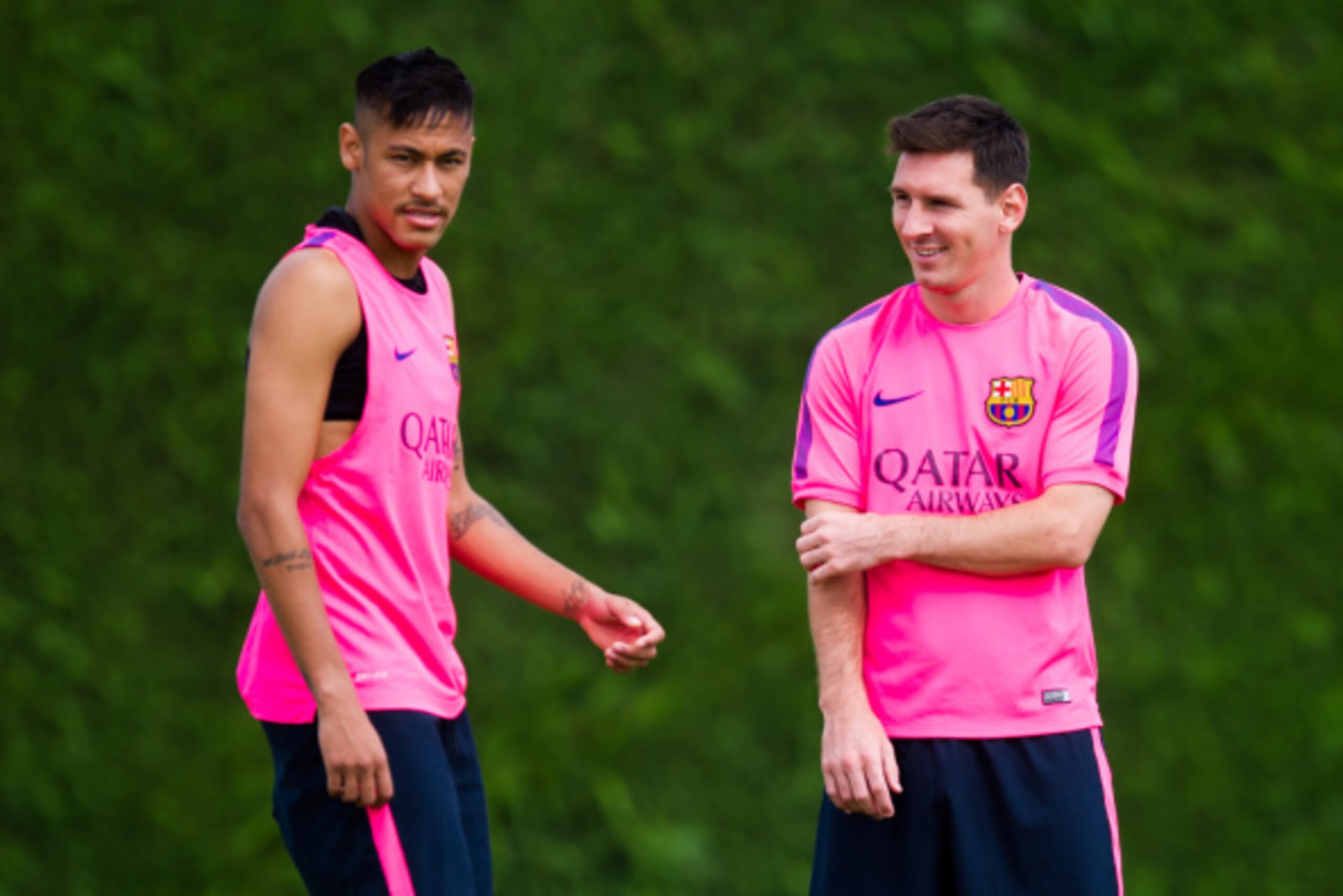 BARCELONA, SPAIN - AUGUST 17: Neymar  (L) and Lionel Messi (R) look on during a FC Barcelona training session at Ciutat Esportiva on August 17, 2014 in Barcelona, Spain.  (Photo by Alex Caparros/Getty Images)