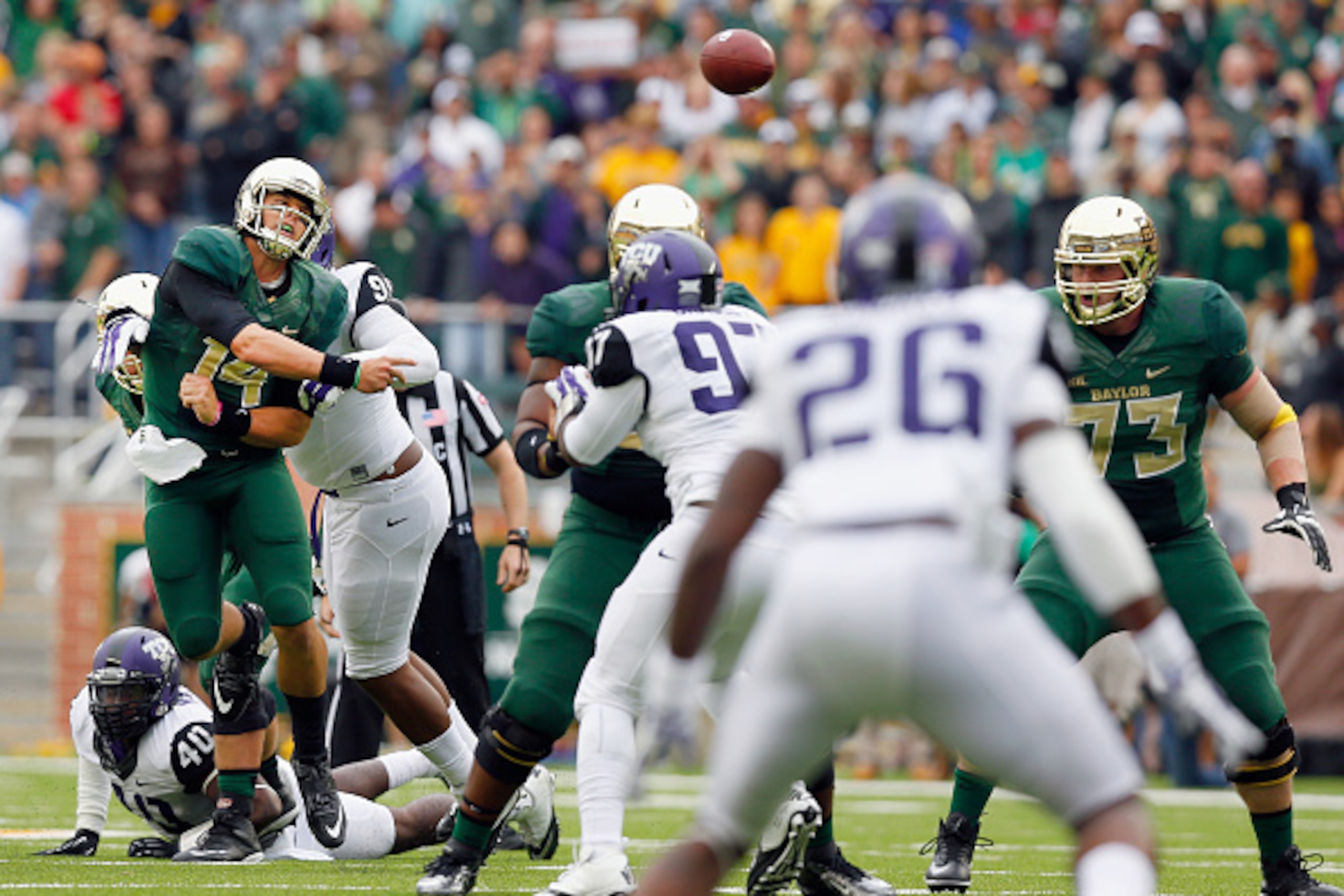 WACO, TX - OCTOBER 11:  Bryce Petty #14 of the Baylor Bears looks for an open receiver in the first half against the TCU Horned Frogs at McLane Stadium on October 11, 2014 in Waco, Texas.  (Photo by Tom Pennington/Getty Images)